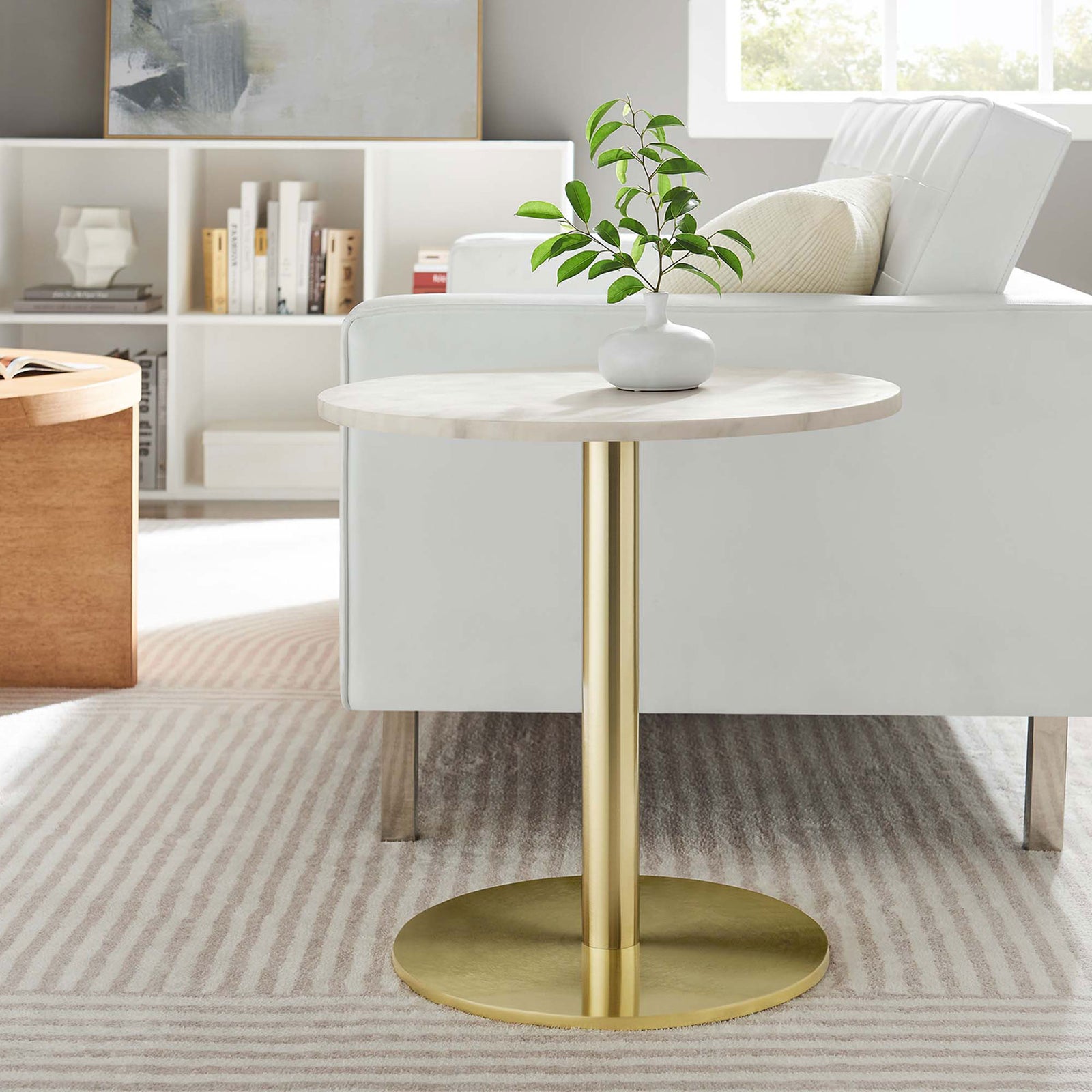 Marble and brass side table styled beside a sofa brings a chic modern accent to a light, inviting living room || EEI-6609-BRA-WHI || front_room