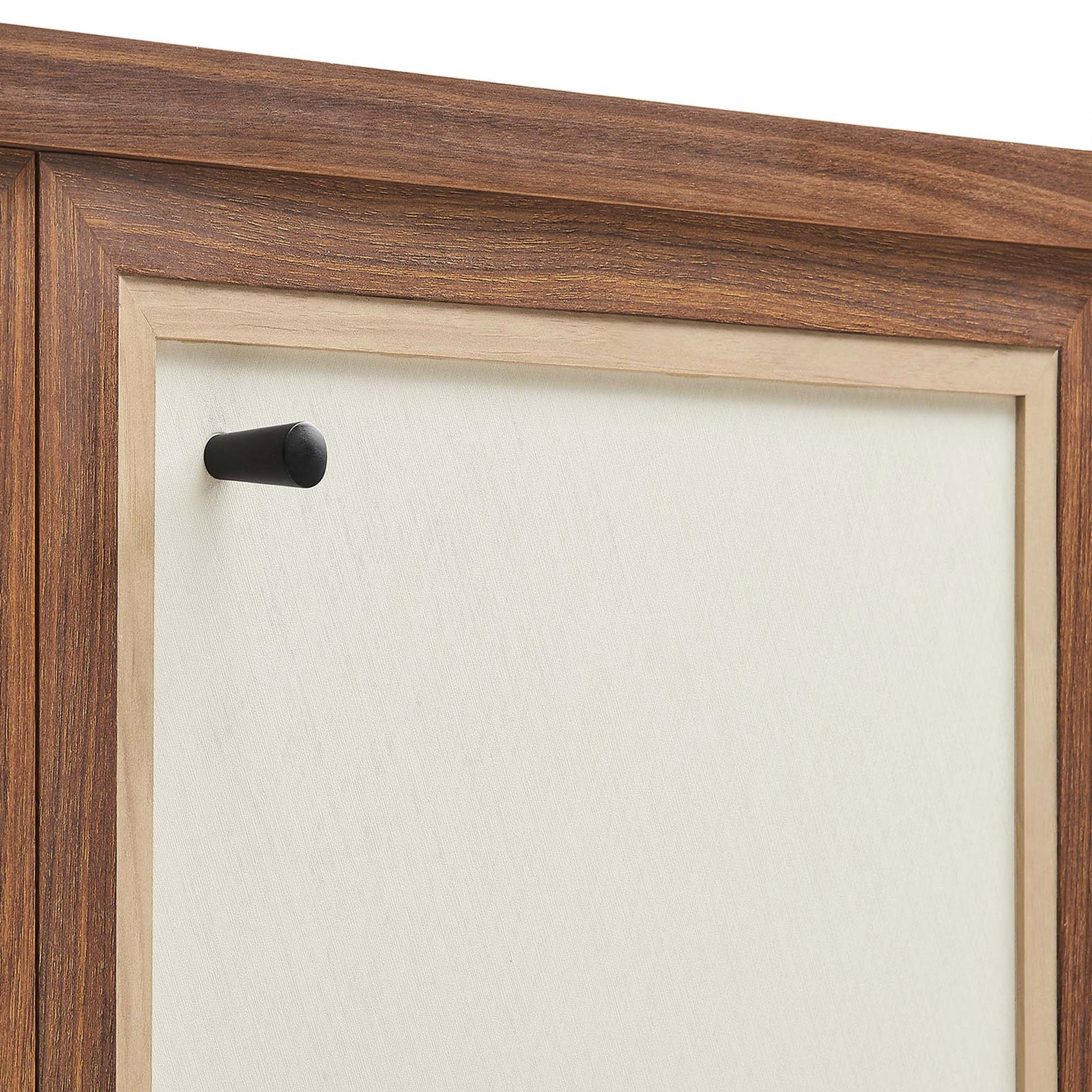 Close-up of minimalist black knob against the linen-textured cabinet door || EEI-6615-WAL || handle_studio