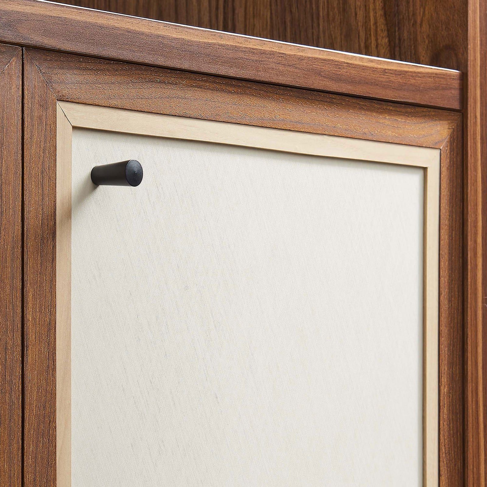 Linen-textured cabinet door accented by a sleek round matte black knob || EEI-6619-WAL || handle_studio
