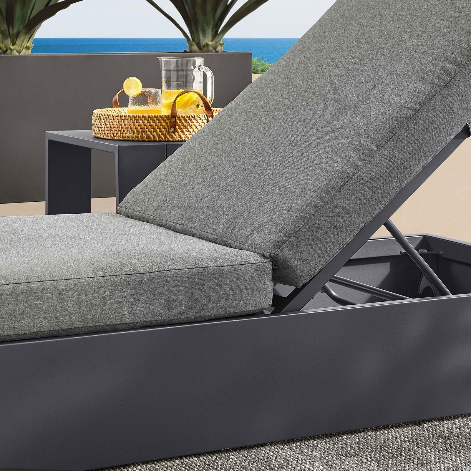 Charcoal cushioned chaise on a modern patio, focusing on the layered cushions and supportive frame || EEI-6634-GRY-CHA || detail_room