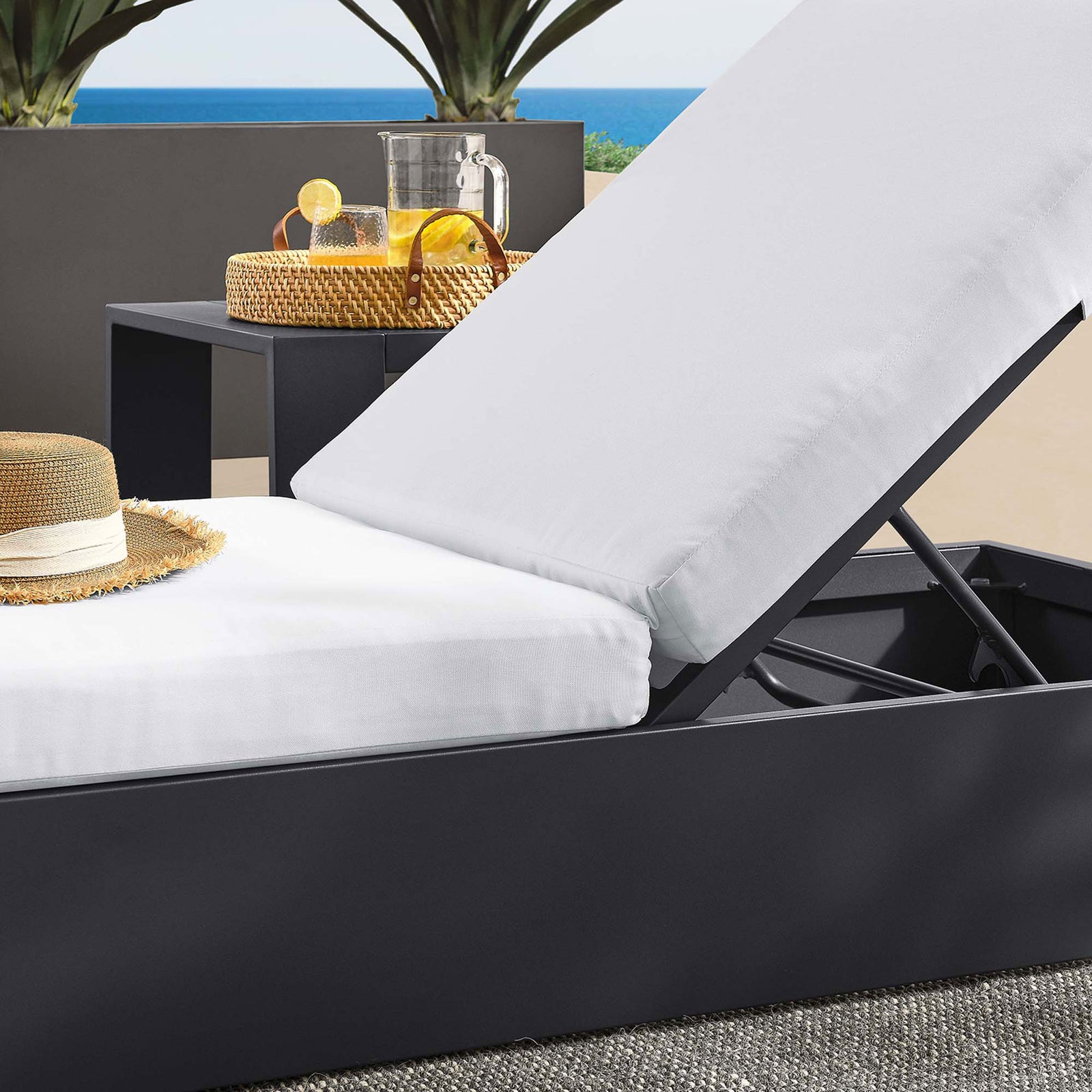White cushioned chaise on a terrace, highlighting the layered cushions and sturdy metal frame || EEI-6634-GRY-WHI || detail_room