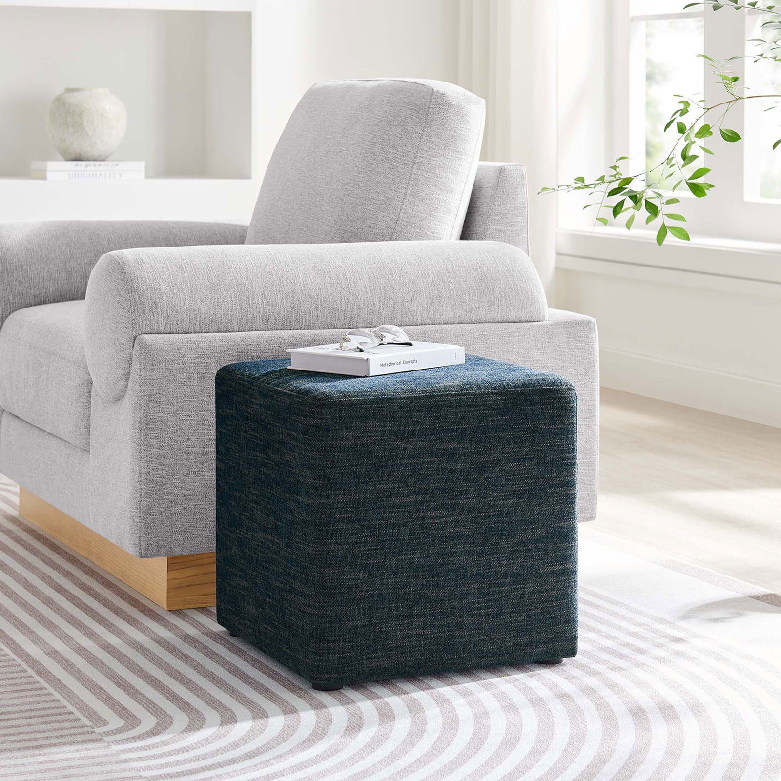 Heathered blue cube ottoman accenting a bright living room, paired with a light gray armchair || EEI-6636-HEA || front_angle_room