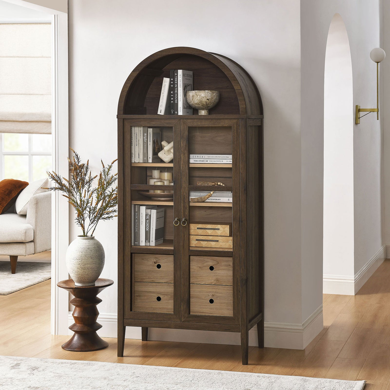 Walnut hickory cabinet filled with books and decor, adding warmth to a hallway or living room || EEI-6639-WAL-HCK || front_angle_room