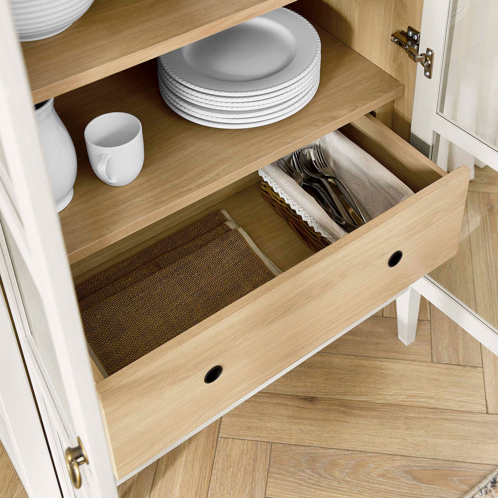 Lower drawer of the white oak cabinet organizing plates, cutlery, and woven table linens || EEI-6639-WHI-OAK || storage_open_room