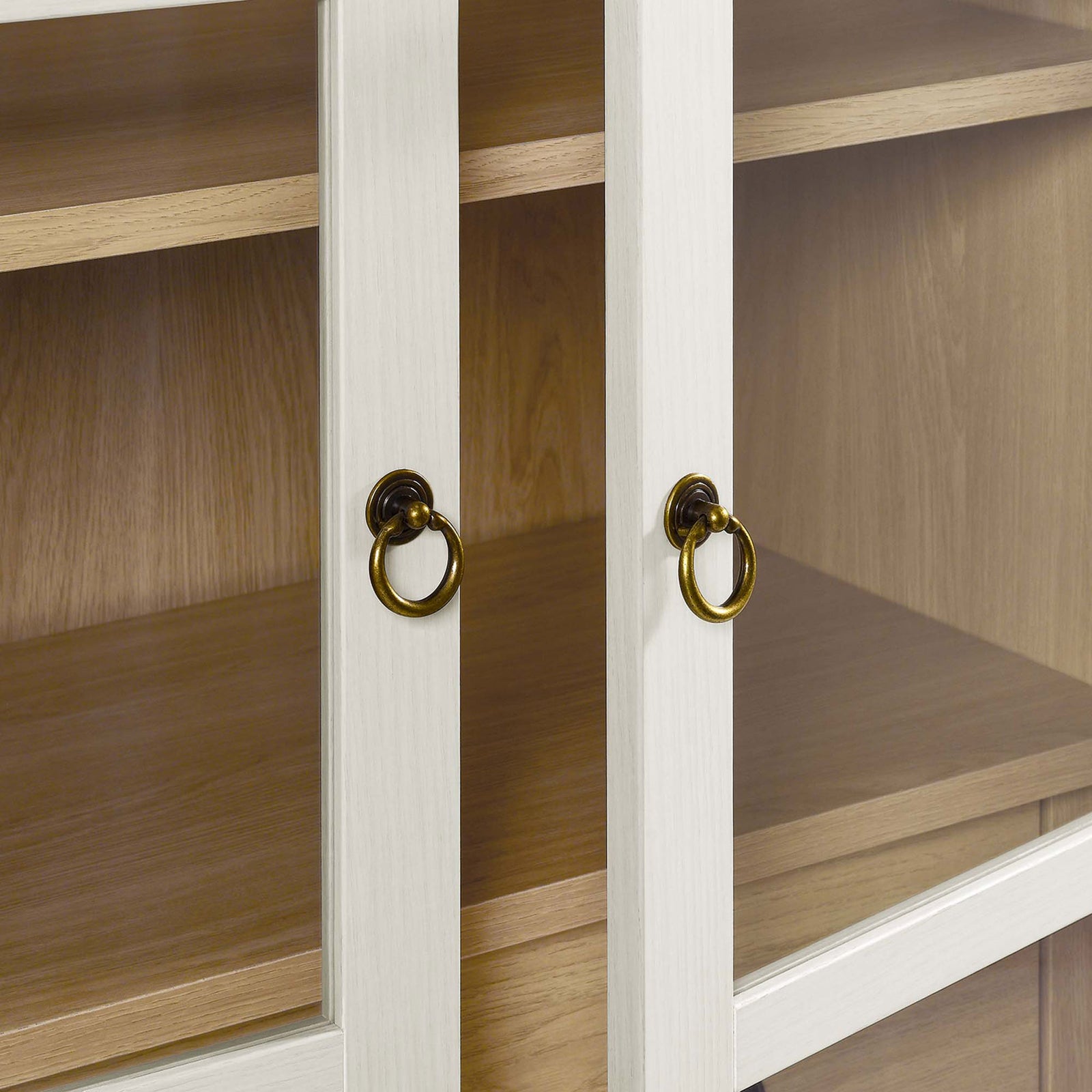 Brushed gold ring pulls stand out against the white oak framed glass doors || EEI-6639-WHI-OAK || handle_studio