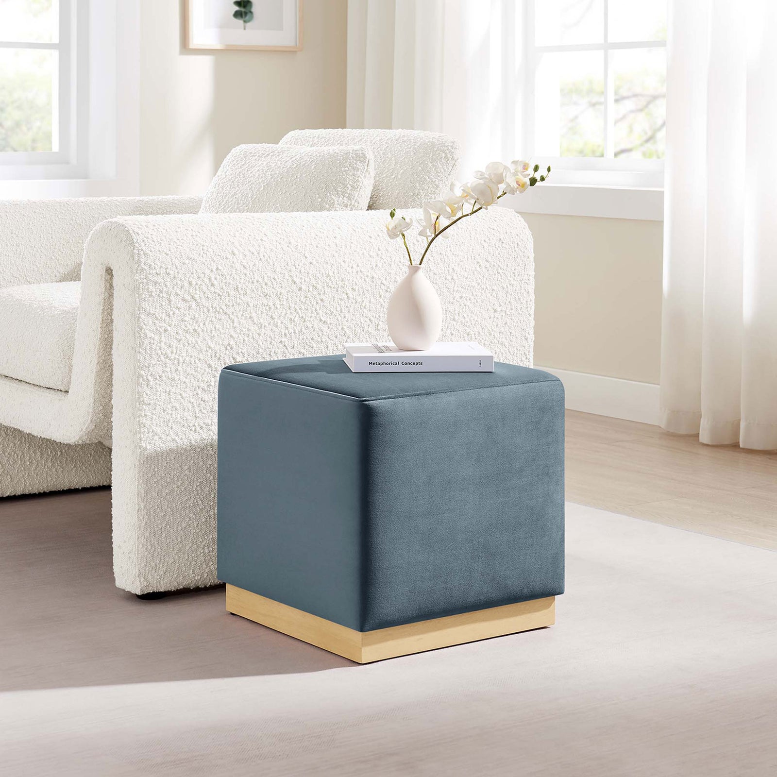 Cadet blue velvet ottoman complements a light, cozy living room as a versatile accent seat or table. || EEI-6640-CAB-NAT || front_angle_room