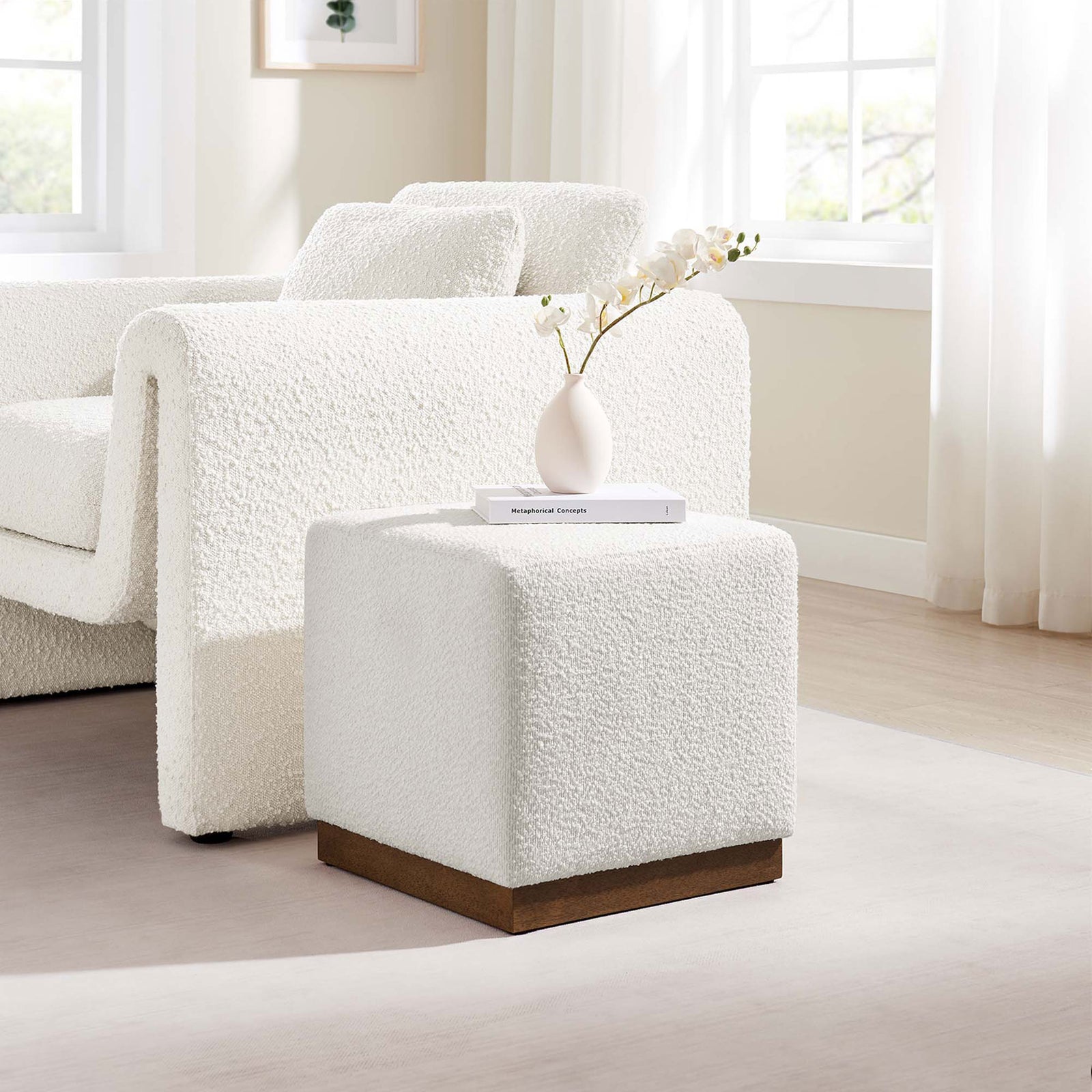 Cloud boucle ottoman pairs with a matching sofa, serving as a modern side table or extra seat in a bright living room. || EEI-6641-CLO-WAL || front_angle_room