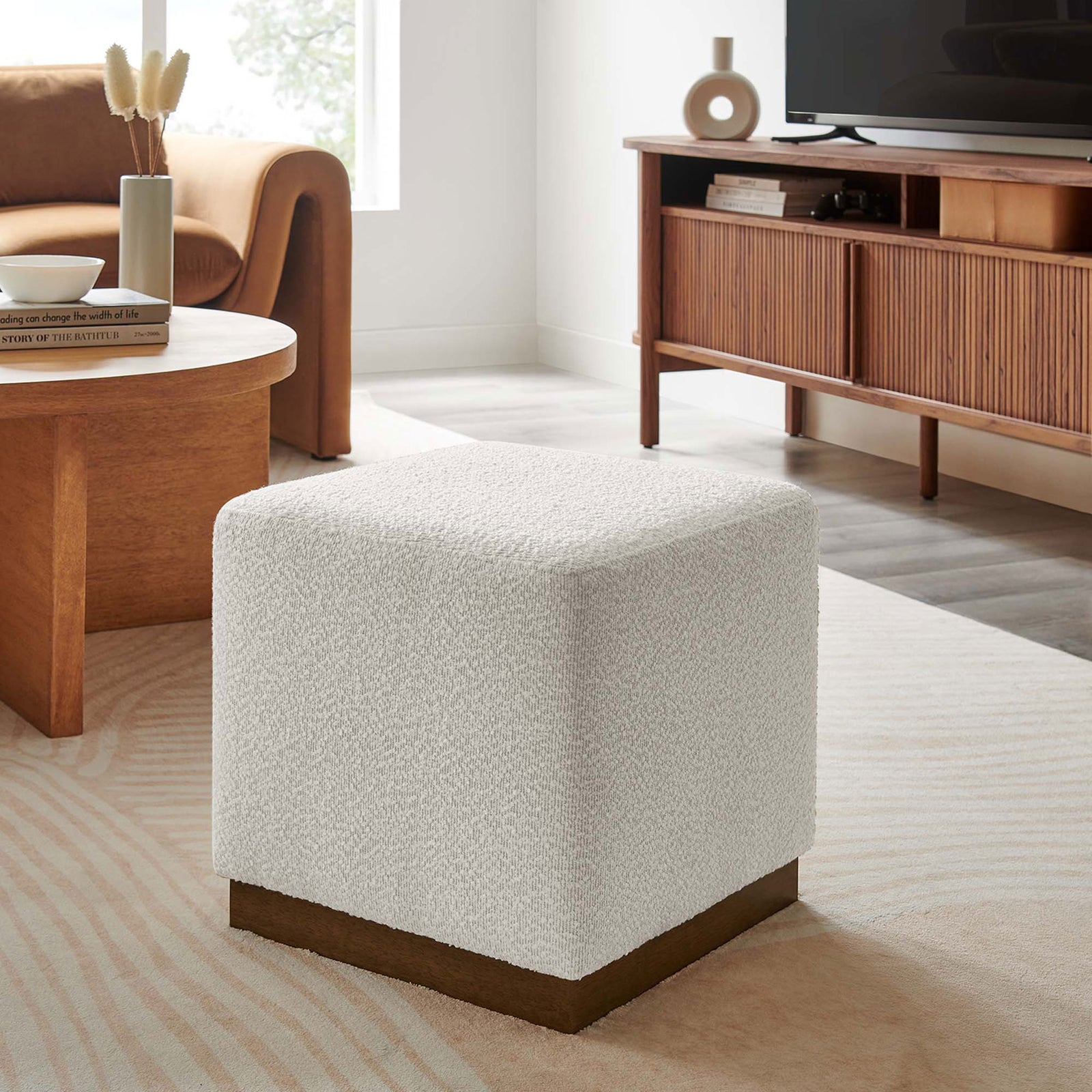Textured cloud boucle ottoman adds soft contrast to warm wood furniture, ideal as a footrest or flexible accent seat. || EEI-6641-CLO-WAL || front_angle_room