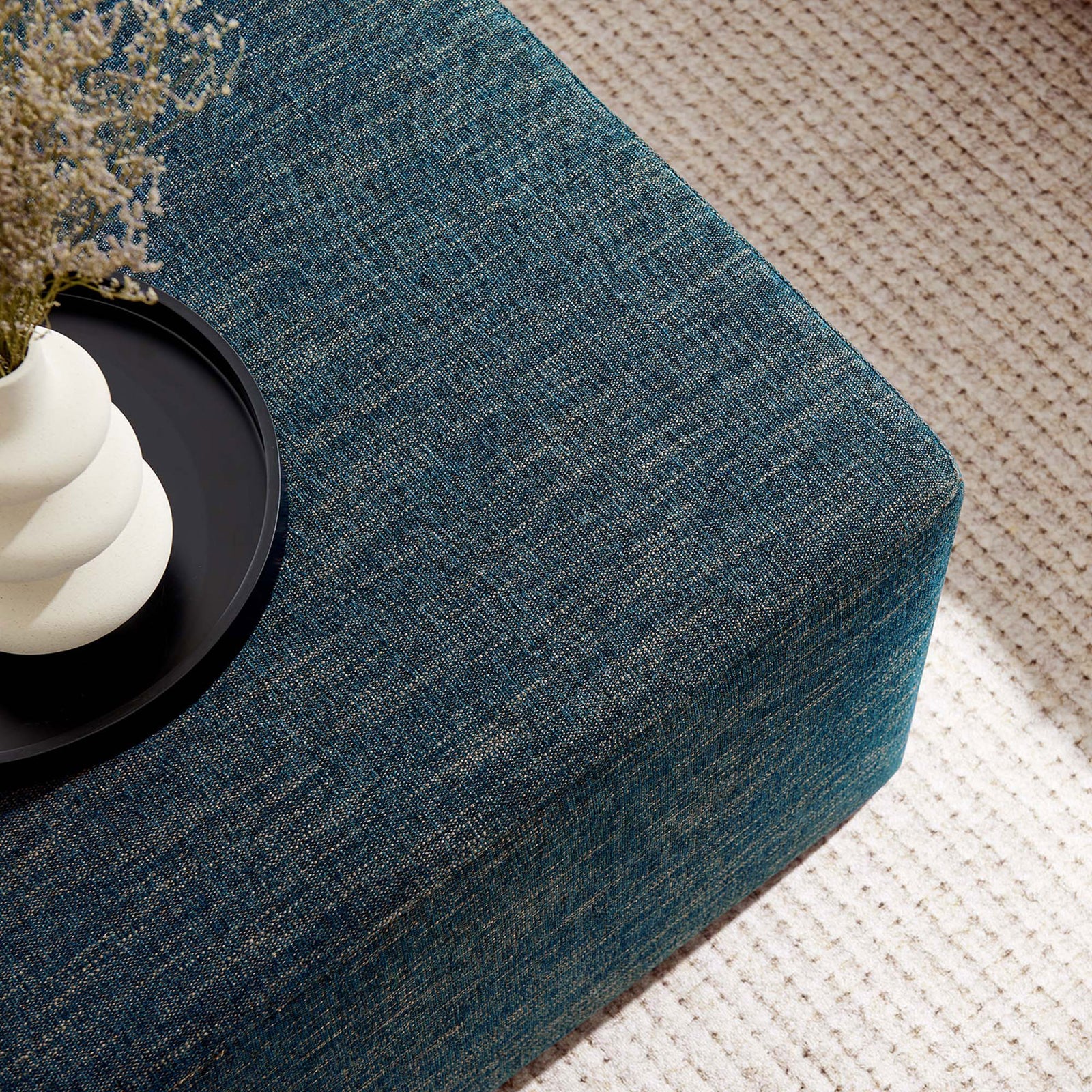 Styled heathered azure ottoman doubles as a coffee table centerpiece on a soft neutral rug. || EEI-6642-HEA || detail_room