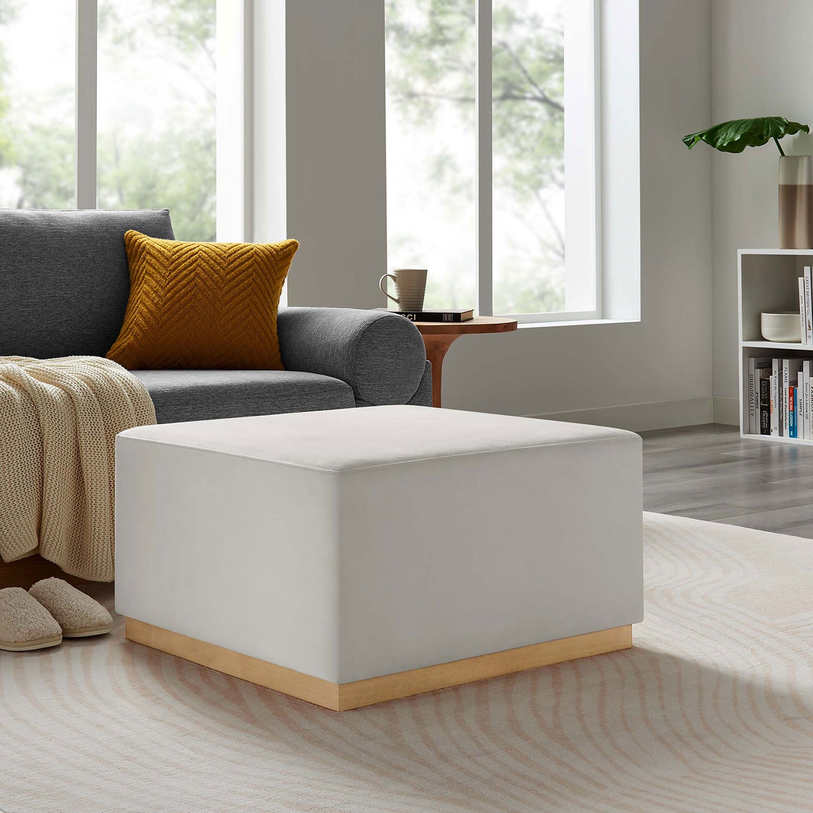 Plush ottoman adds cozy extra seating and footrest space beside a modern sofa and textured rug || EEI-6643-ALA-NAT || front_angle_room