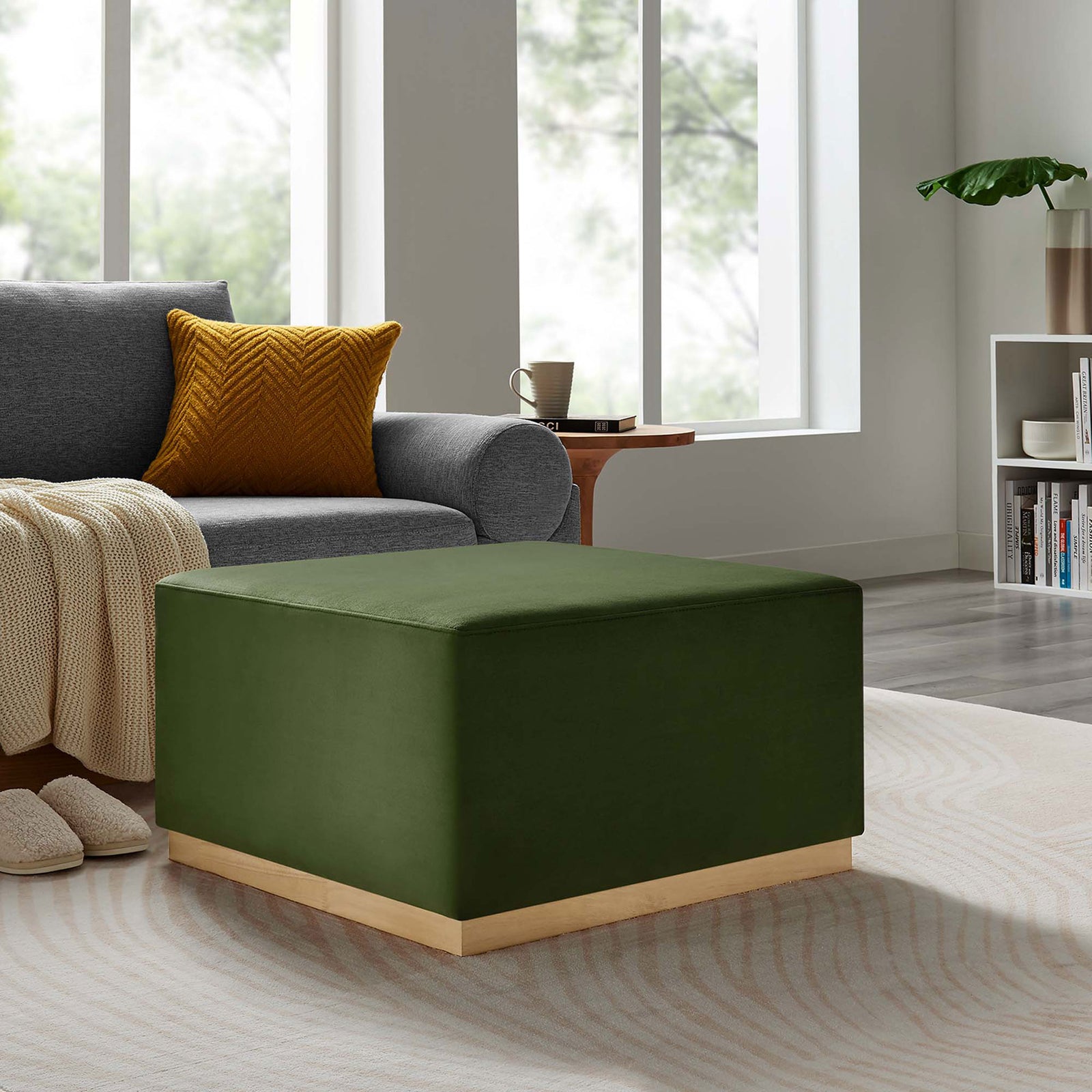 Cozy living room vignette featuring the moss green ottoman as a soft coffee table beside a gray sofa and throw || EEI-6643-MOG-NAT || front_angle_room