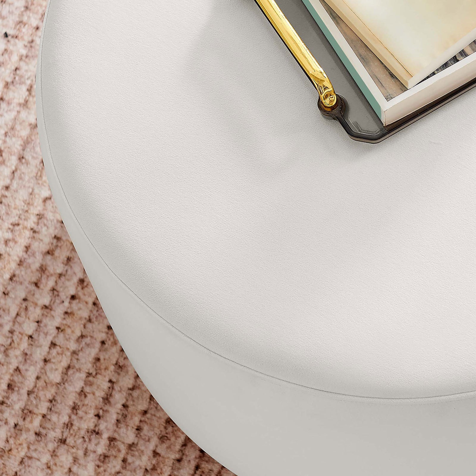 Alabaster ottoman doubles as a chic coffee table with books and decor on its smooth cushioned top. || EEI-6646-ALA-NAT || detail_room