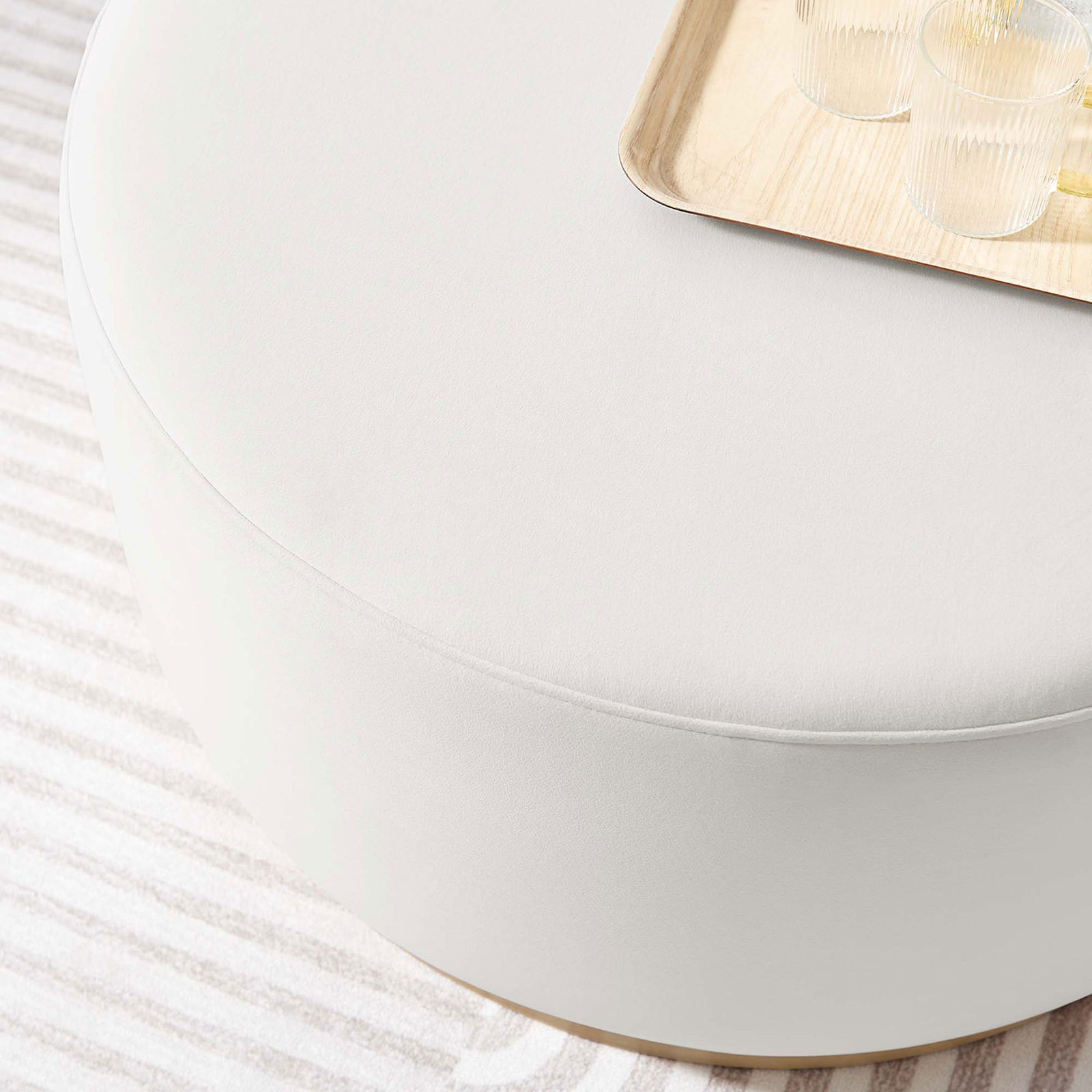 Alabaster velvet Tilden ottoman styled with a tray on a striped rug in a bright modern living room || EEI-6648-ALA-NAT || detail_room