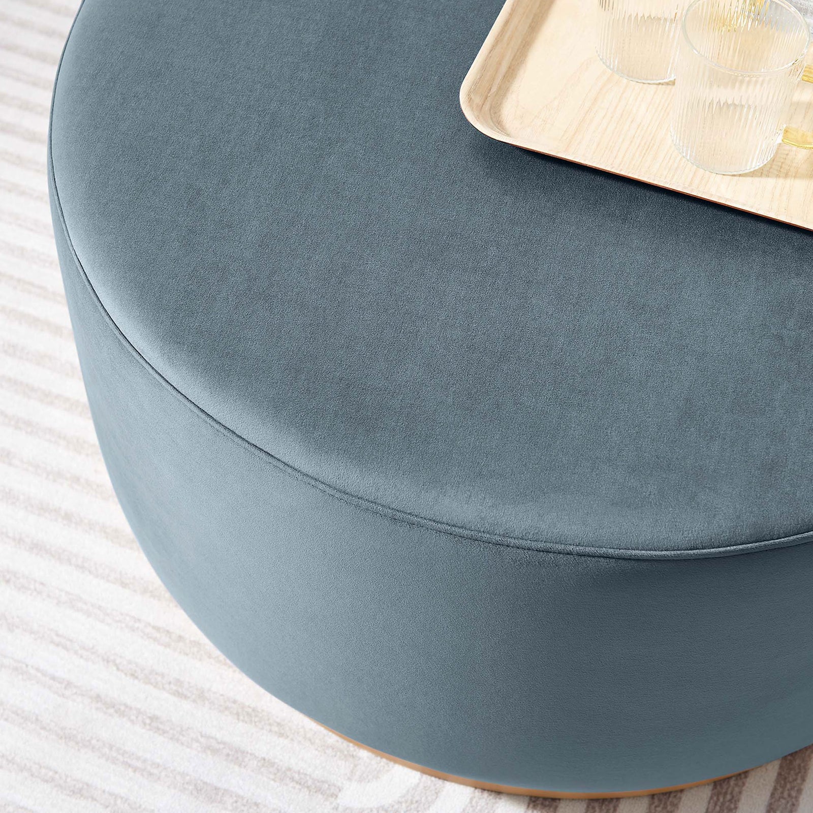 Tilden round velvet ottoman used as a coffee table with a tray and drinks in a bright living space || EEI-6648-CAB-NAT || detail_room