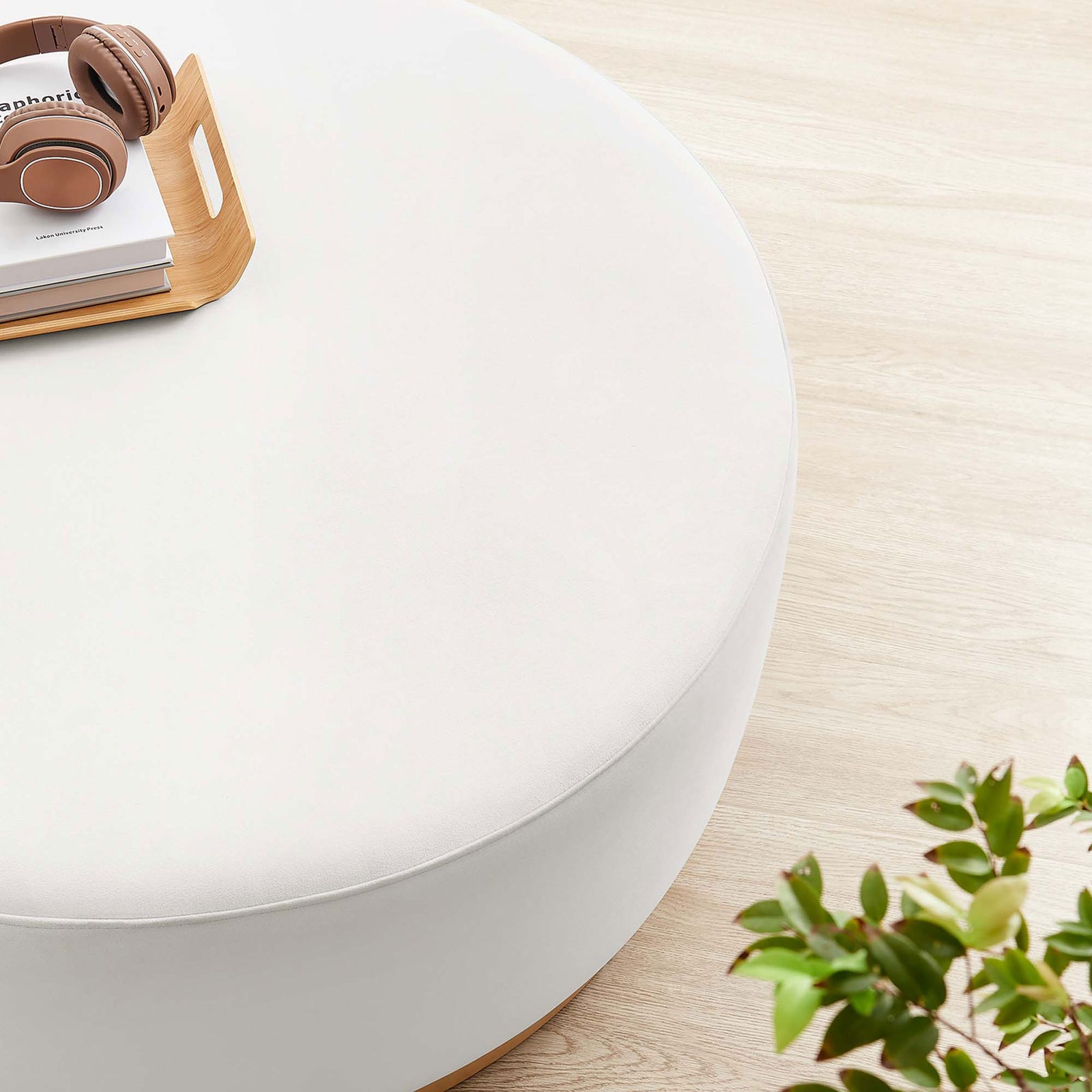 Alabaster velvet 38 inch Tilden ottoman styled with books and headphones on a light wood floor || EEI-6650-ALA-NAT || detail_room