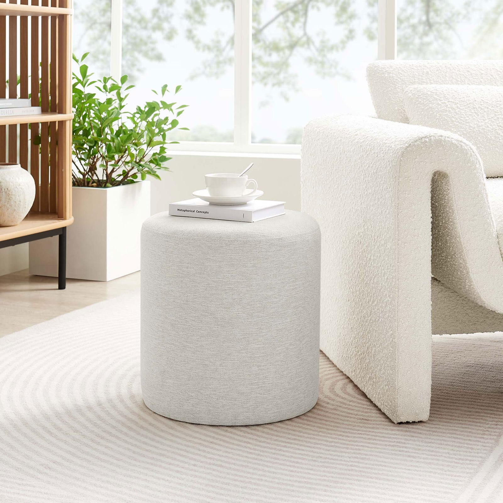 Heathered ivory ottoman brings soft texture and extra seating to a bright, airy living room setting. || EEI-6651-HEI || front_room