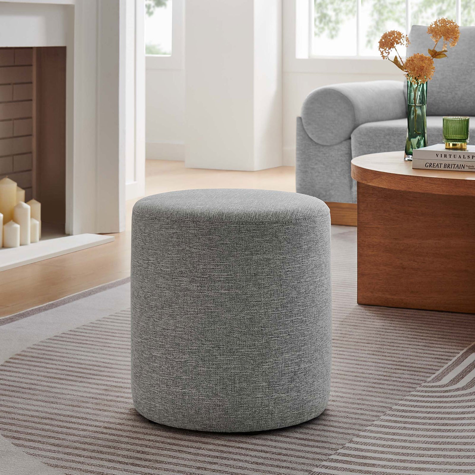 Heathered light gray ottoman next to a wood coffee table and sofa in a cozy contemporary living room || EEI-6651-HLG || front_angle_room