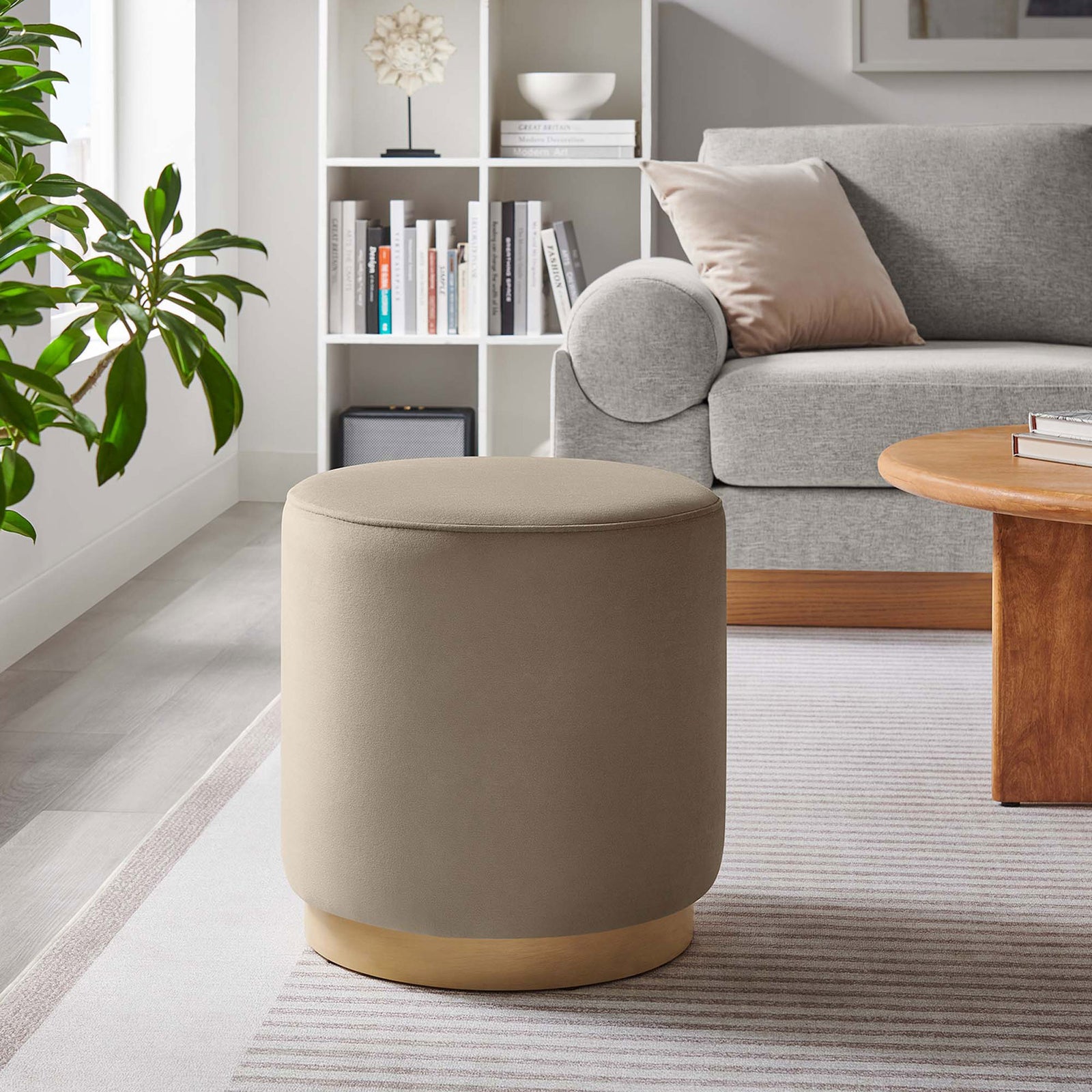 Taupe velvet ottoman adding soft texture and extra seating in a bright contemporary living room || EEI-6652-TAU-NAT || front_angle_room