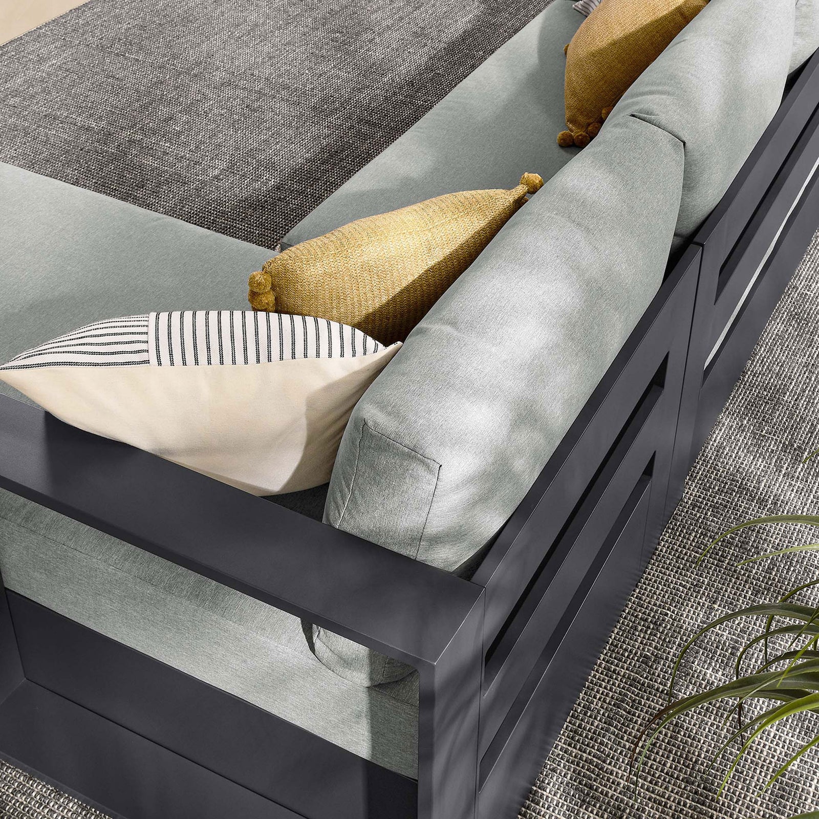 Layered throw pillows and soft cushions lend relaxed comfort to the Tahoe sectional seating || EEI-6669-GRY-GRY || detail_room