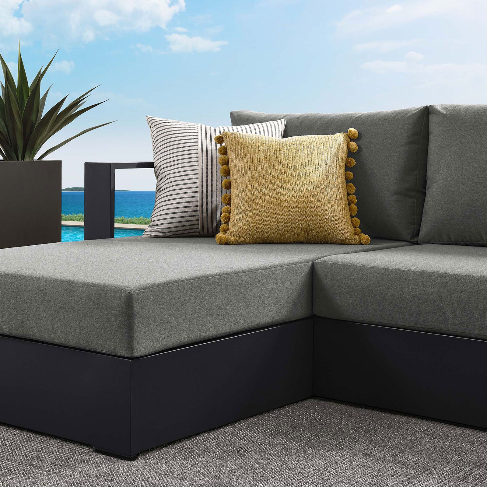 Charcoal cushions and patterned accent pillows add inviting texture to the Tahoe sectional corner || EEI-6670-GRY-CHA || detail_room