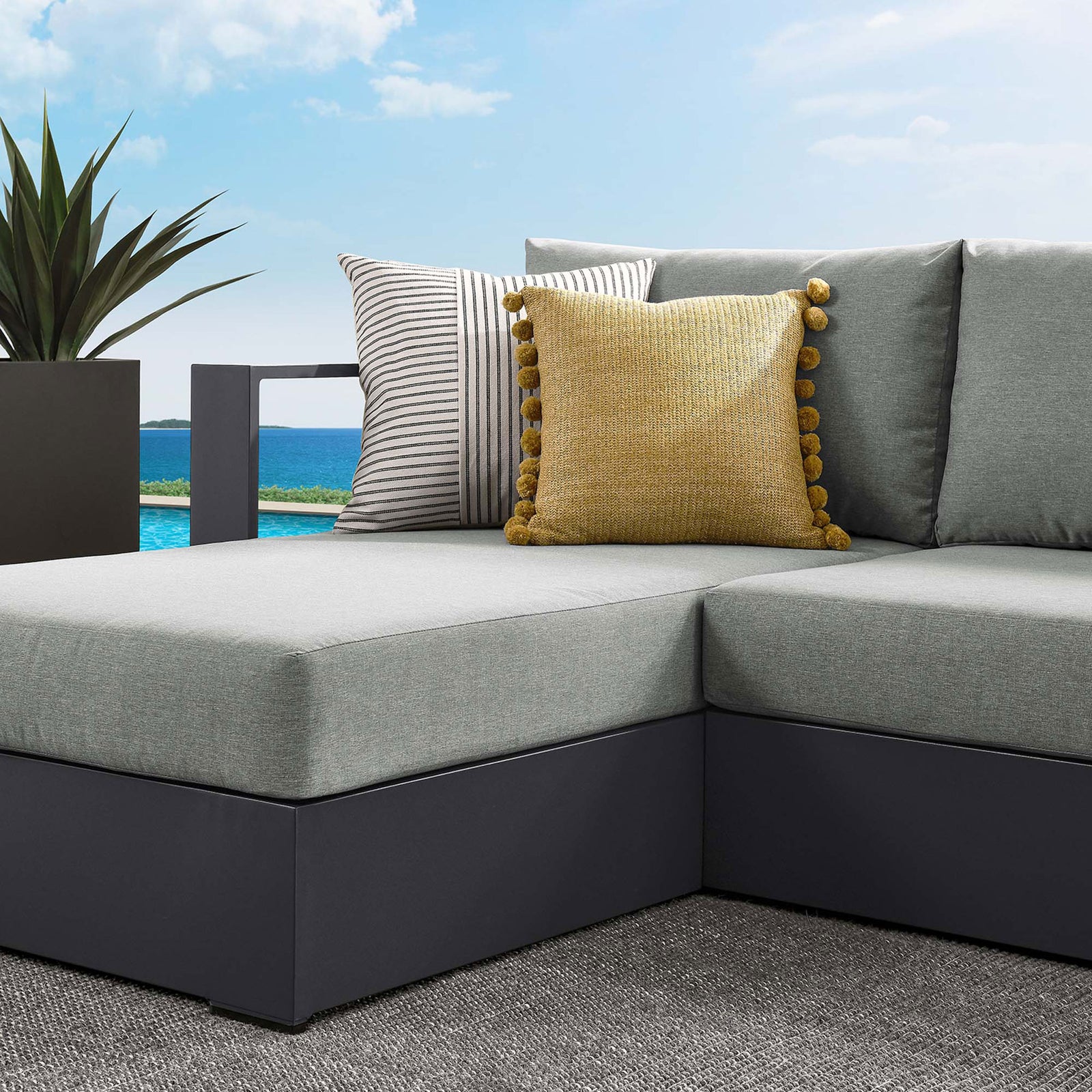 Light gray cushions and mixed-pattern pillows bring soft contrast to the Tahoe sectional corner || EEI-6670-GRY-GRY || detail_room