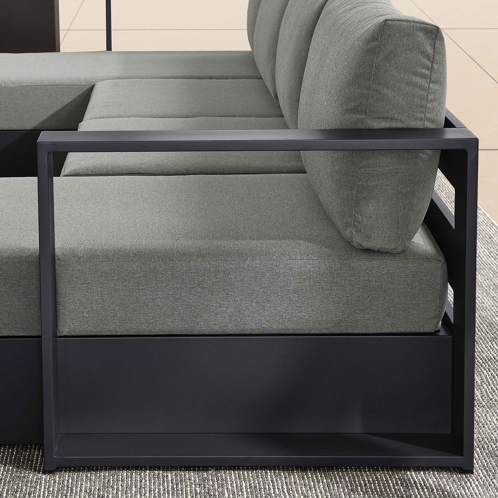 Linear metal arm and thick charcoal cushions bringing modern structure to the Tahoe outdoor sectional seating || EEI-6676-GRY-CHA || detail_room