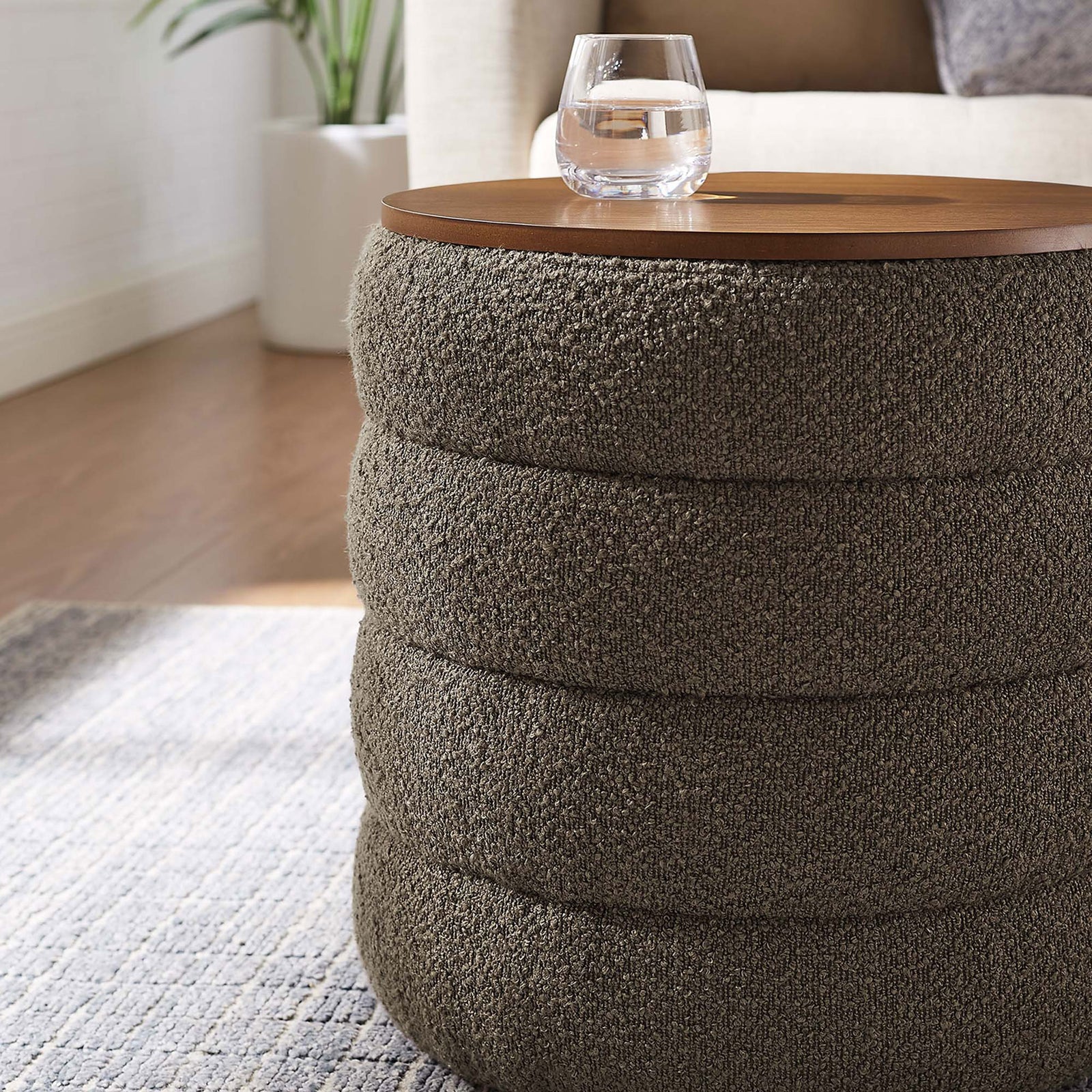 Round pebble boucle storage ottoman doubles as a chic bedside table in a soft neutral bedroom || EEI-6685-PEB || detail_room