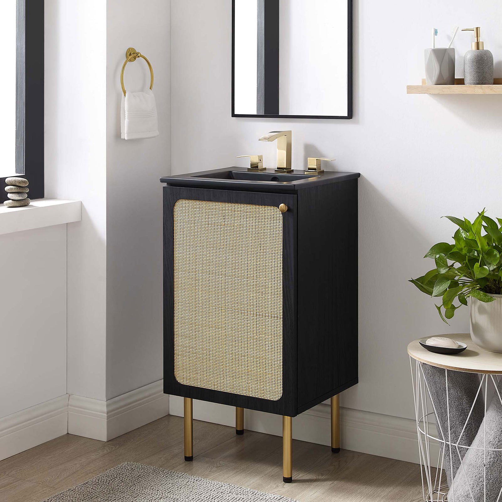 Sleek black vanity with rattan door and gold accents elevates a modern bath nook || EEI-6692-BLK-BLK || front_angle_room