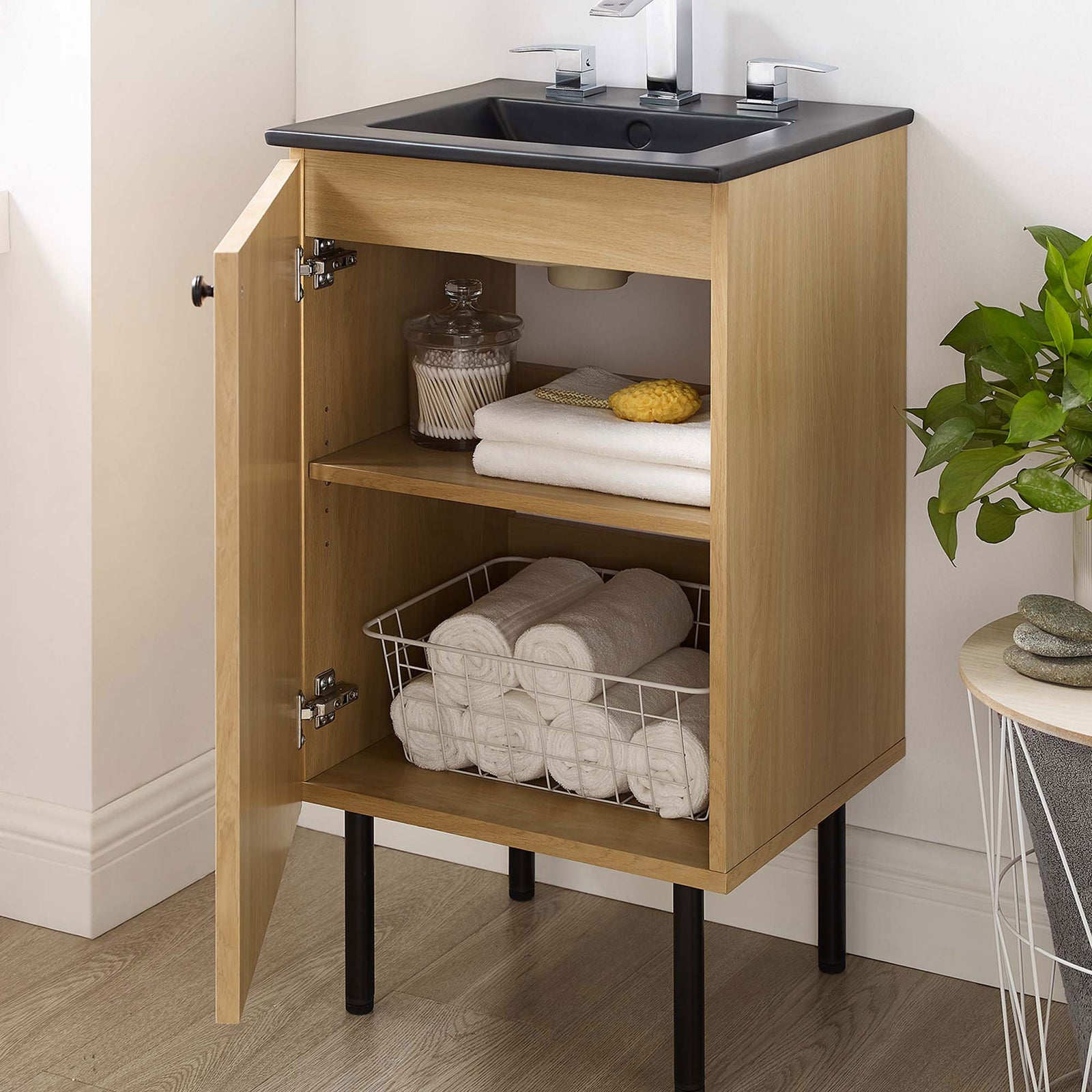 Generous storage with adjustable shelf keeps towels organized in a stylish oak and black vanity || EEI-6692-OAK-BLK || front_open_room