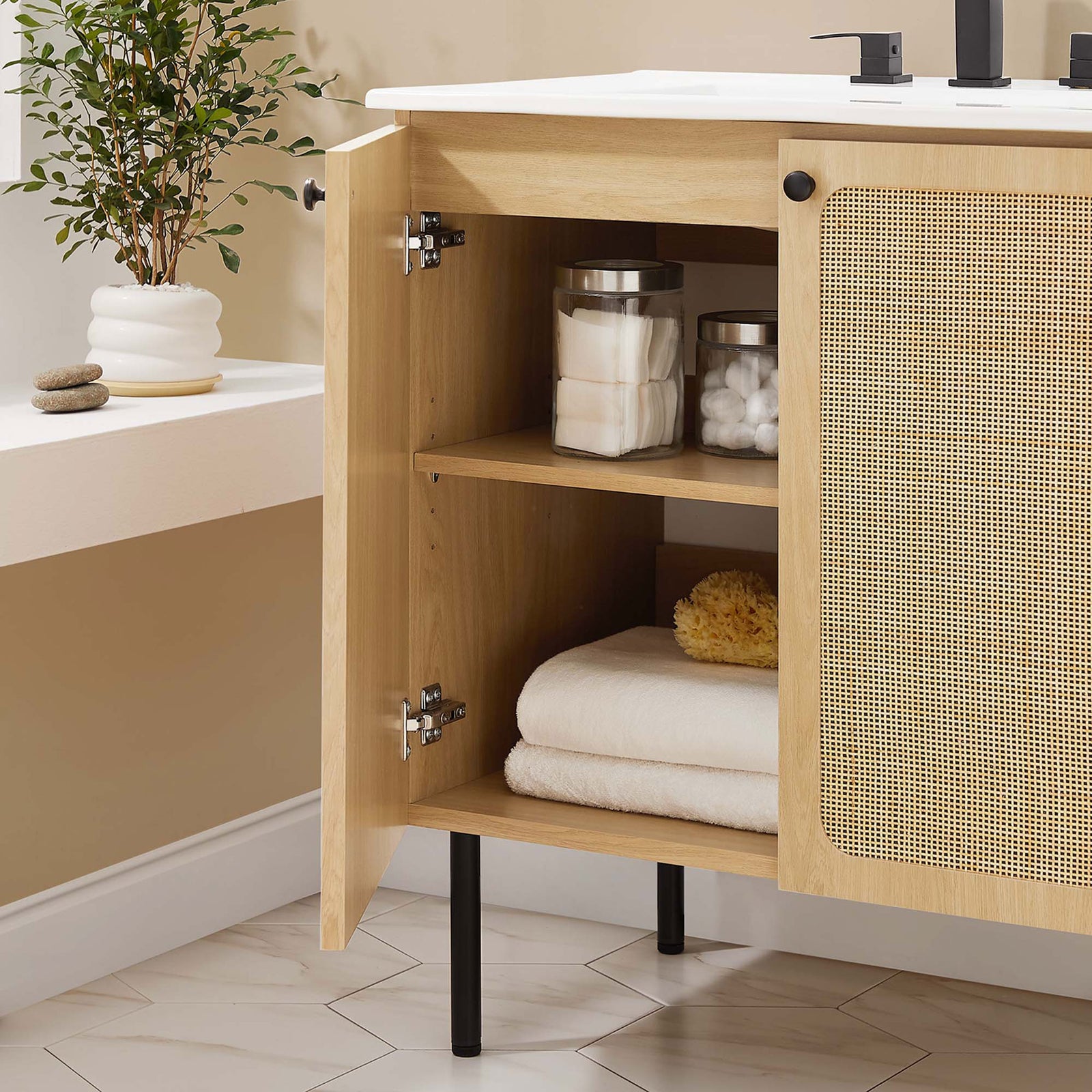 Roomy interior storage keeps bath essentials organized behind dual rattan doors || EEI-6695-OAK-WHI || front_open_room