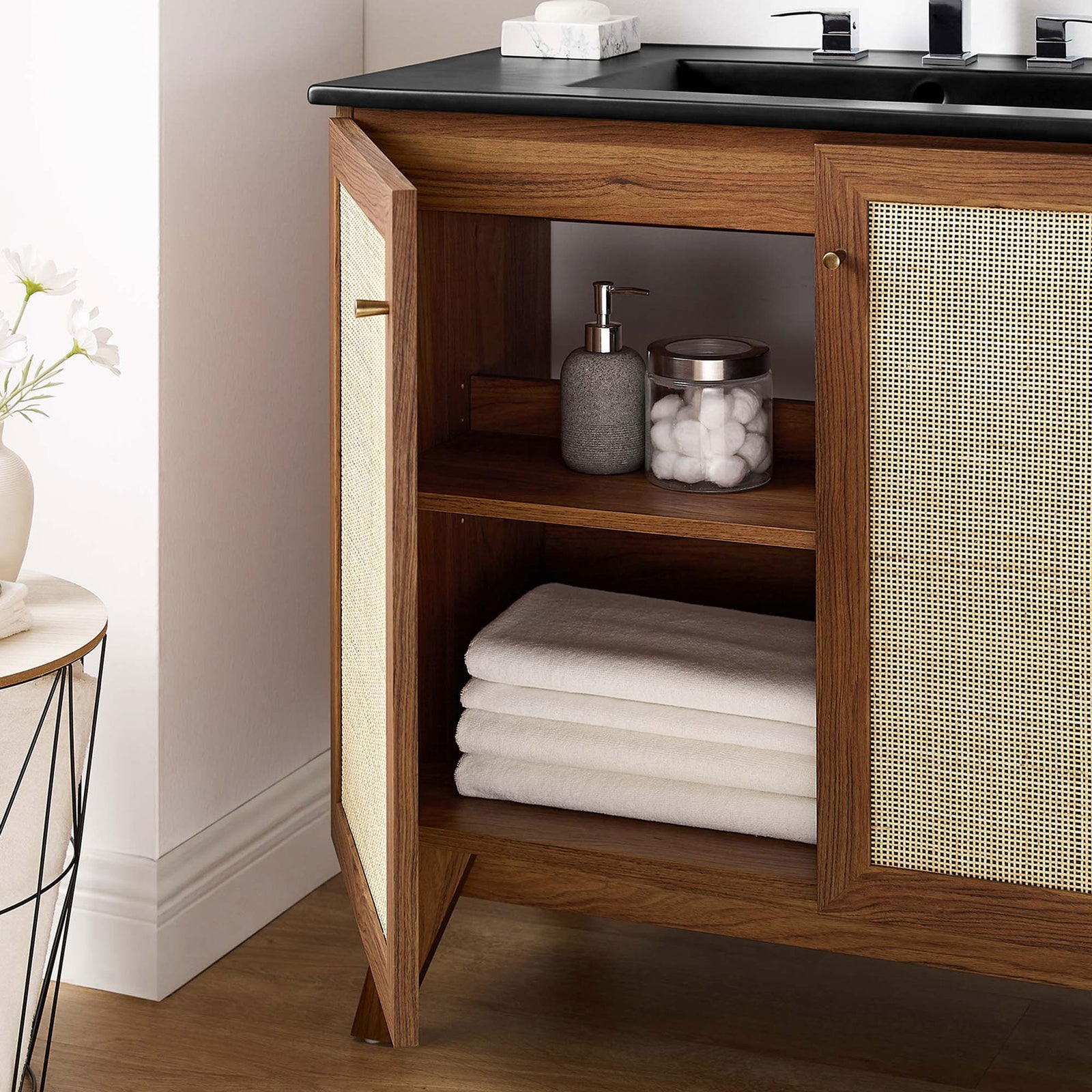 Interior shelf keeps linens and bottles tidy behind the textured cane doors. || EEI-6718-WAL-BLK || storage_open_room
