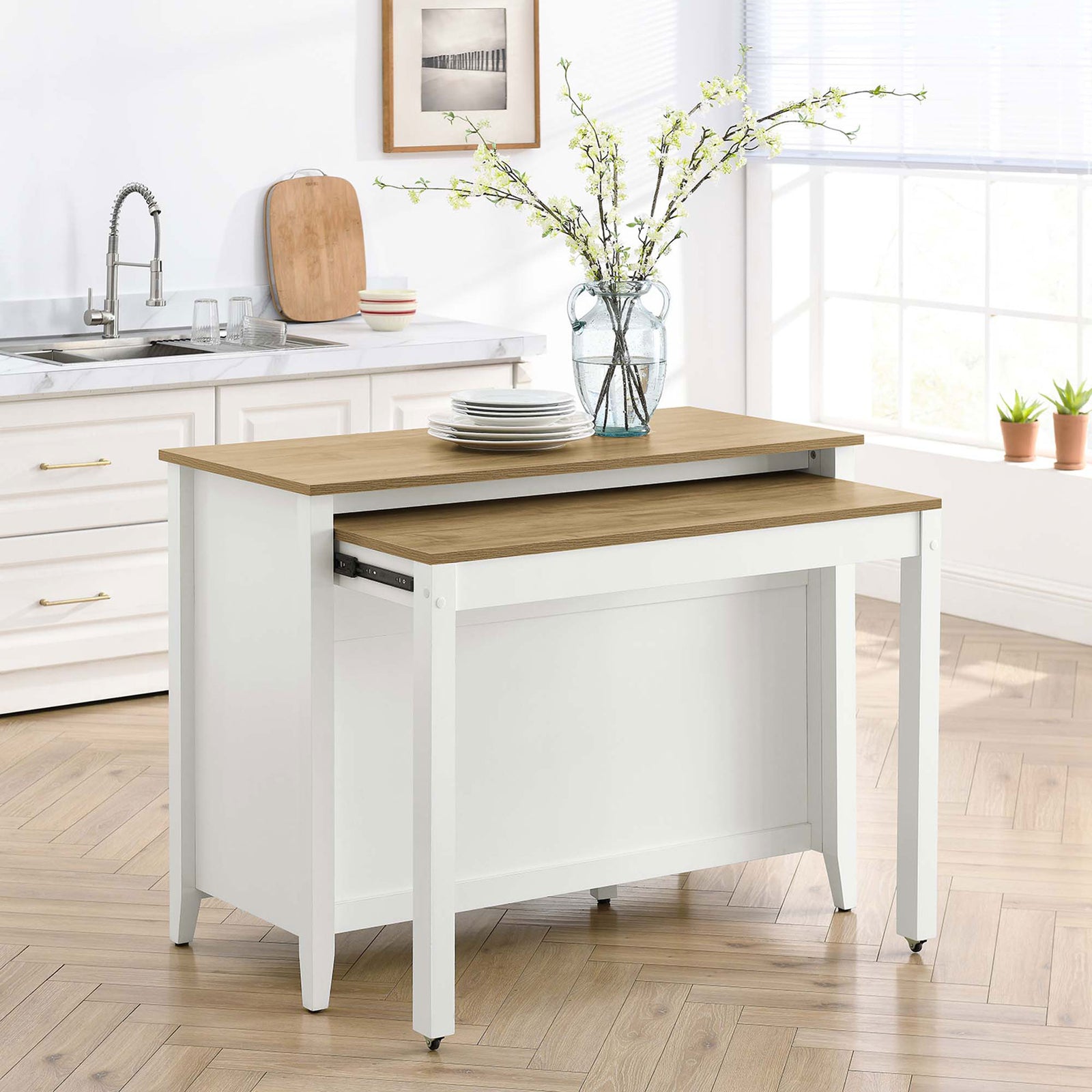 Kitchen island with pull out table extended and set with plates and drinks for casual kitchen dining || EEI-6727-OAK-WHI || back_angle_converted_room