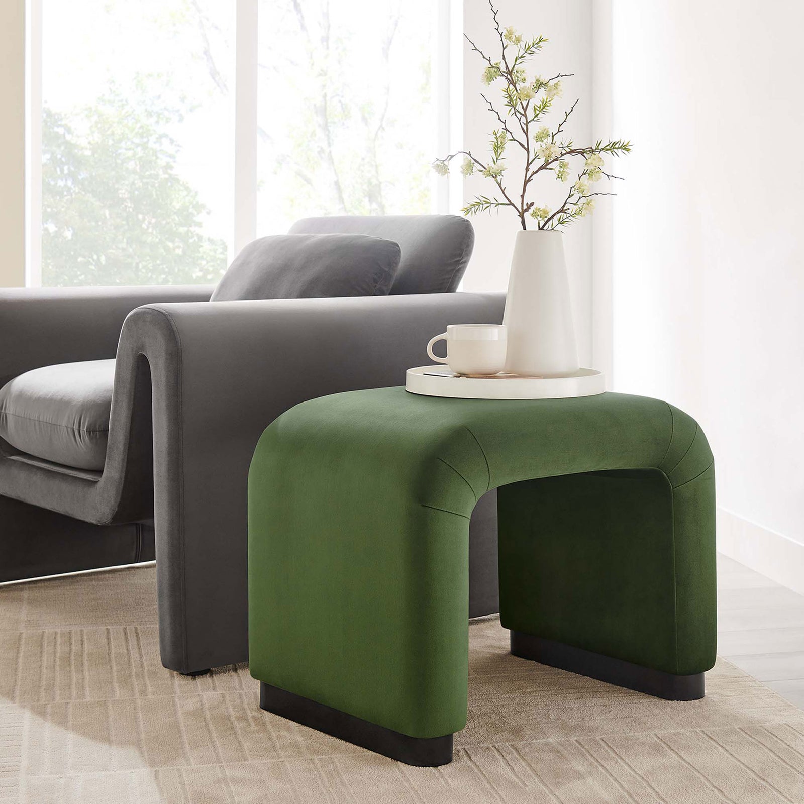 Functions as a chic side table or extra seat, adding color and curve to the room || EEI-6733-BLK-MOS || front_angle_room