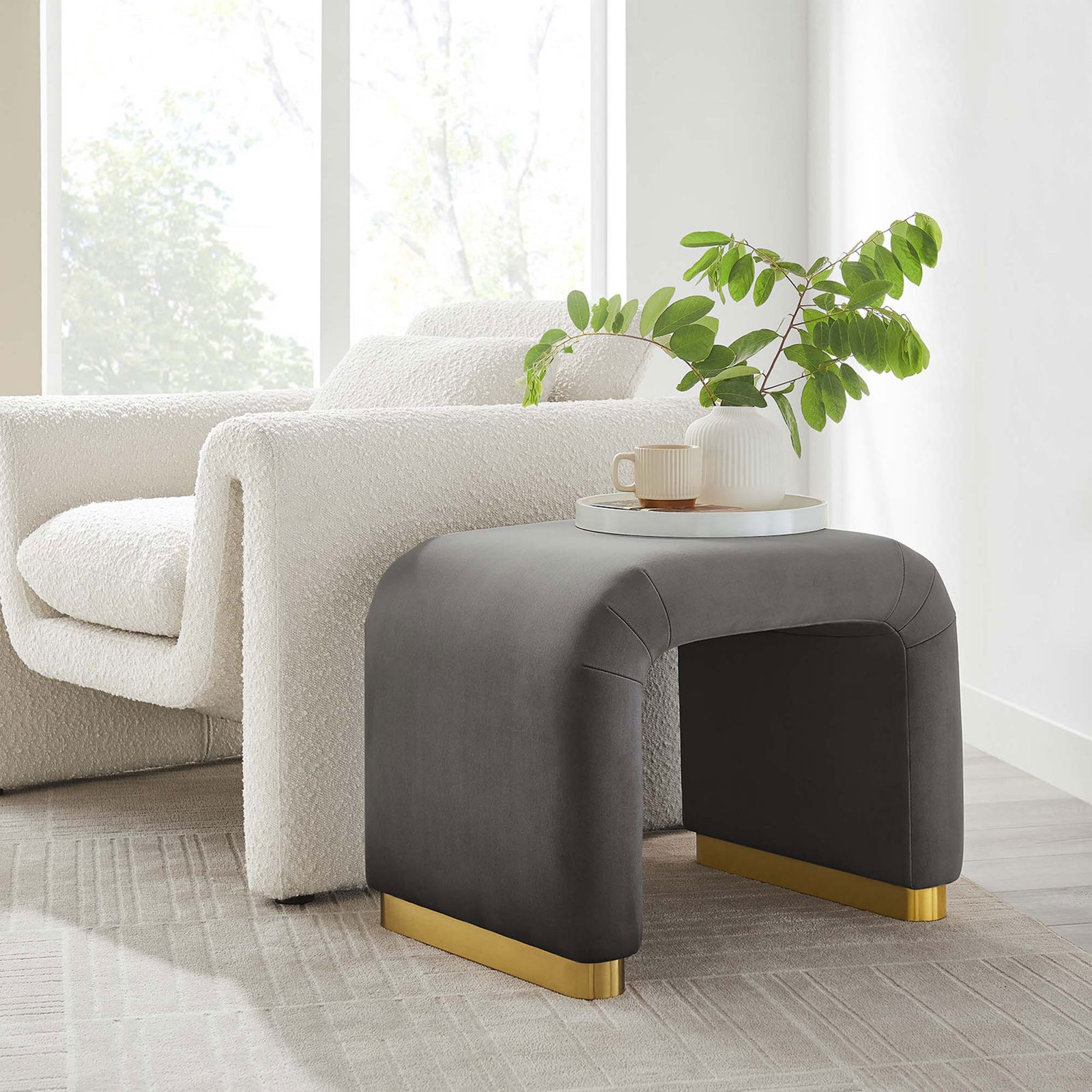 Doubles as a side table, pairing plush velvet with a sturdy brass base for everyday use || EEI-6733-BRA-STG || front_angle_room