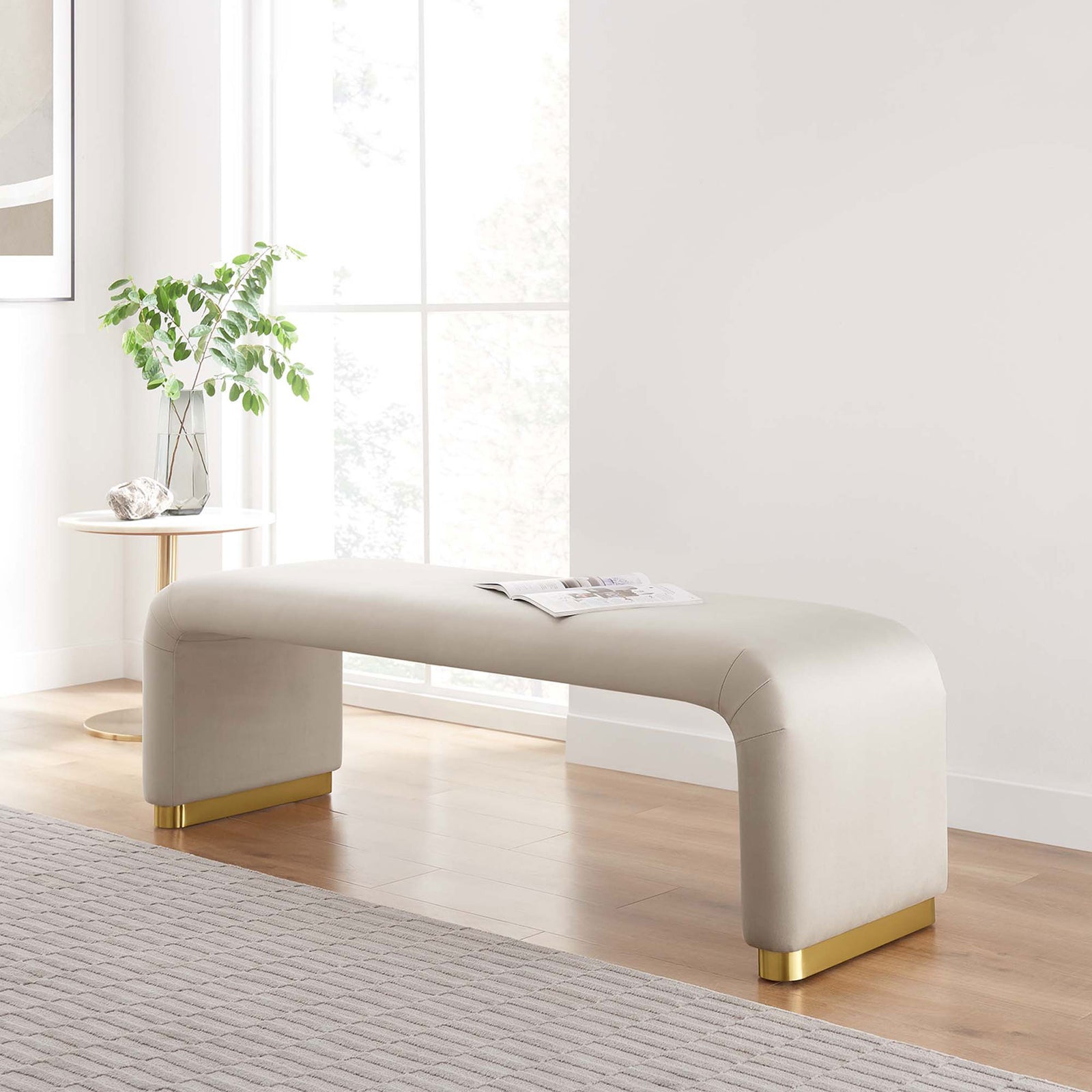 Modern glam bench in almond velvet with brass accents, bringing soft curves and shine to the living room || EEI-6734-BRA-ALM || front_angle_room