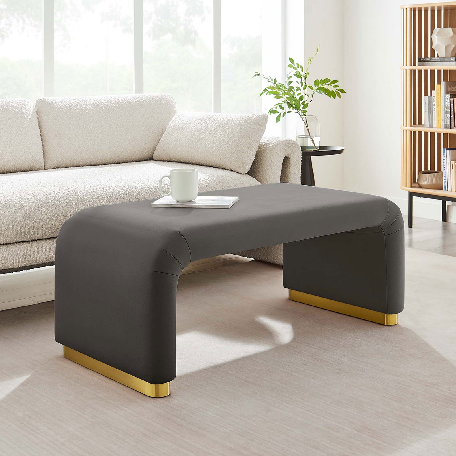 Gray performance velvet waterfall ottoman anchors a serene living space with light furnishings and natural accents || EEI-6735-BRA-STG || front_angle_room
