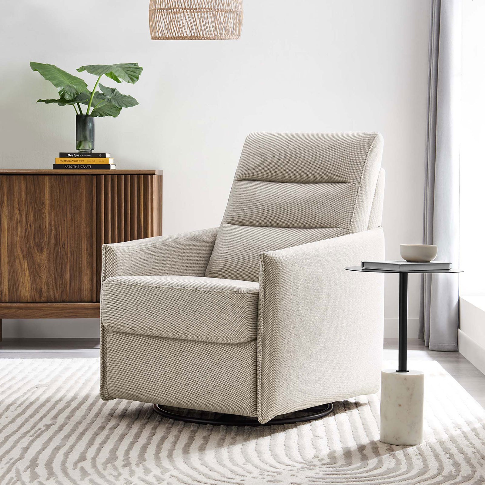 Elevates any room with clean lines, oatmeal fabric, and effortless swivel and glide for relaxing moments || EEI-6738-OAT || front_angle_room
