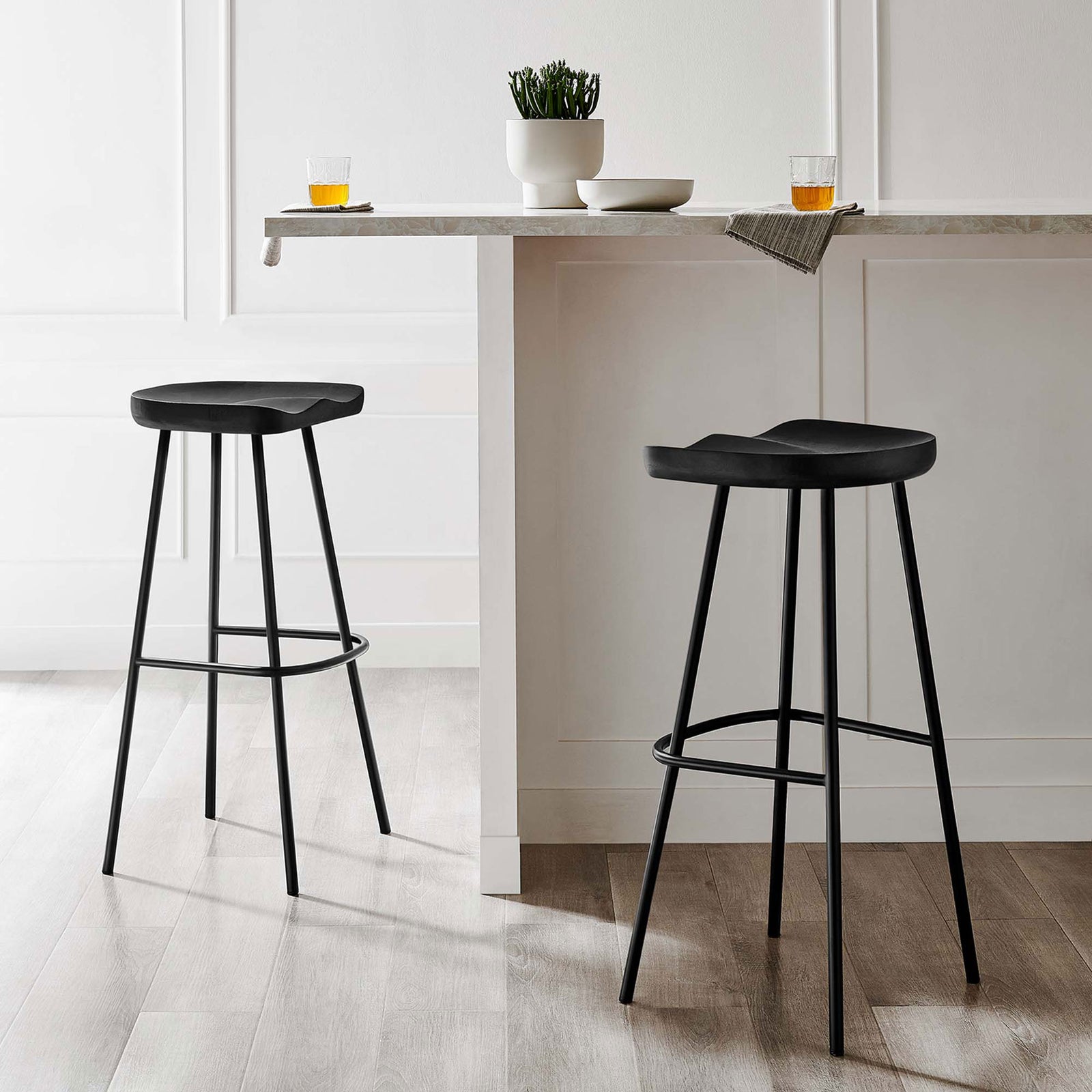 Two black bar stools bring streamlined style to a bright, minimalist kitchen || EEI-6742-BLK || front_angle_multi_room