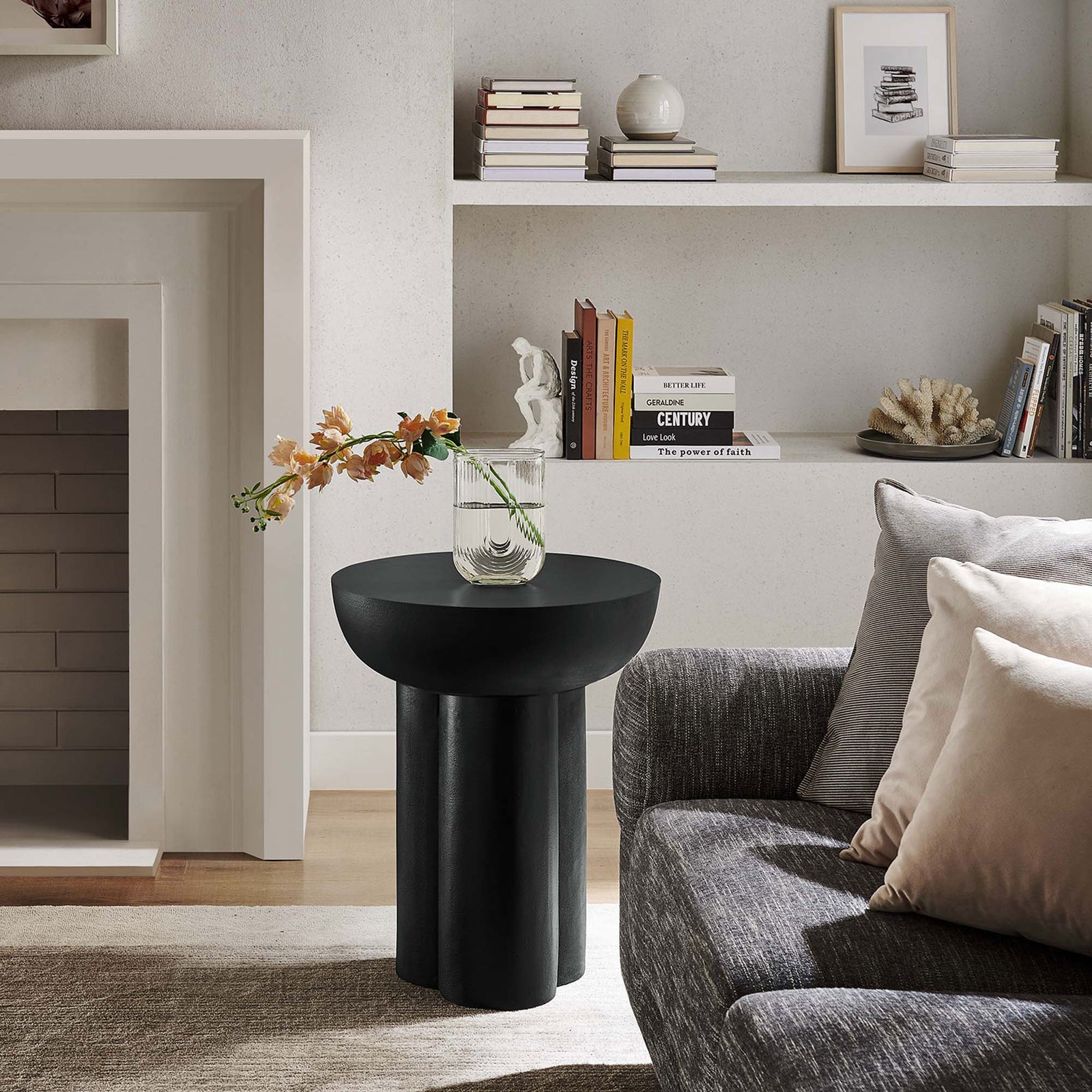 Contemporary living room featuring the Caspian black concrete overlay side table styled with decor by the fireplace || EEI-6761-BLK || front_angle_room