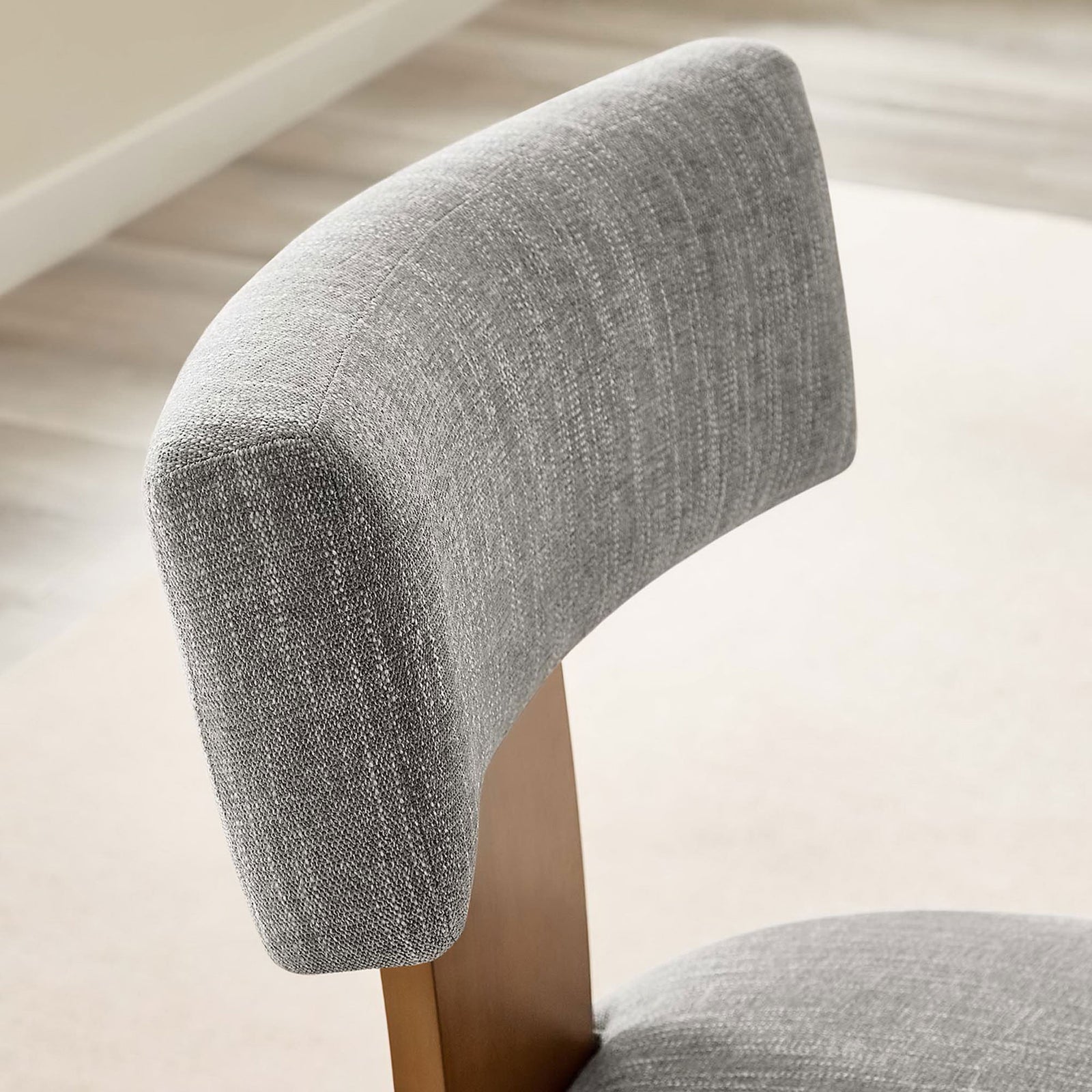 Close-up of dining chair backrest showing the soft heathered fabric in a bright room setting. || EEI-6777-HEW-DBR || detail_room