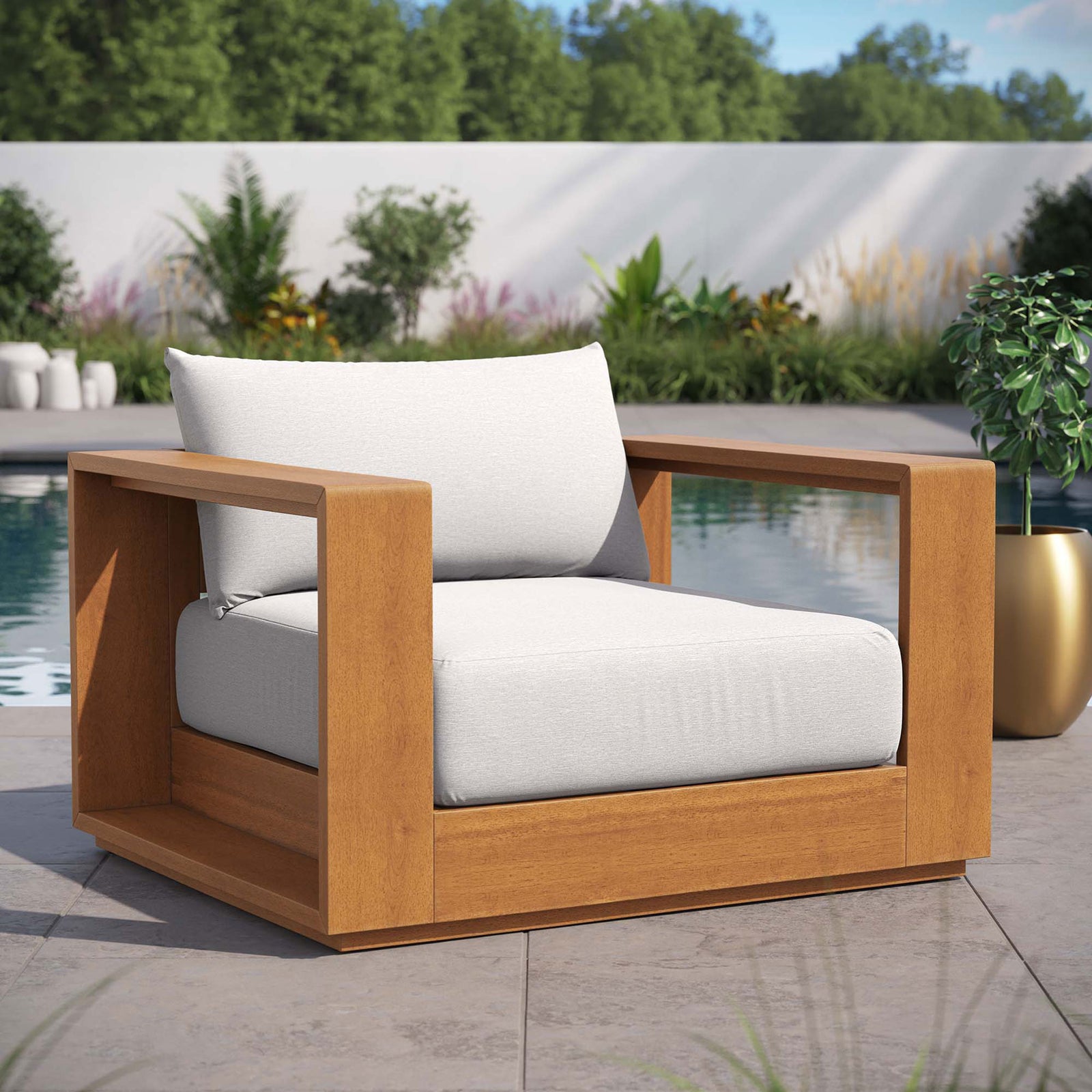 Tahoe acacia outdoor chair with light gray cushions styled beside a modern poolside garden || EEI-6782-NAT-LGR || front_angle_room