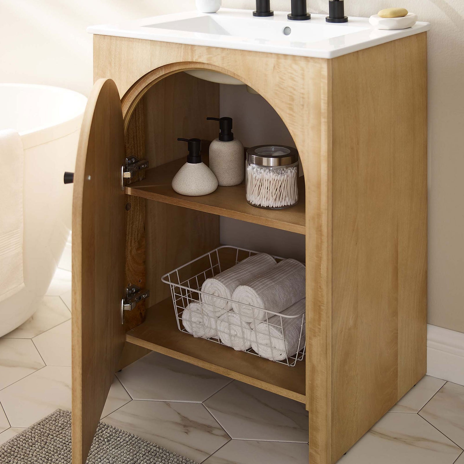 Generous storage behind the arched door keeps towels and bath essentials organized || EEI-6788-OAK-WHI || front_angle_open_room