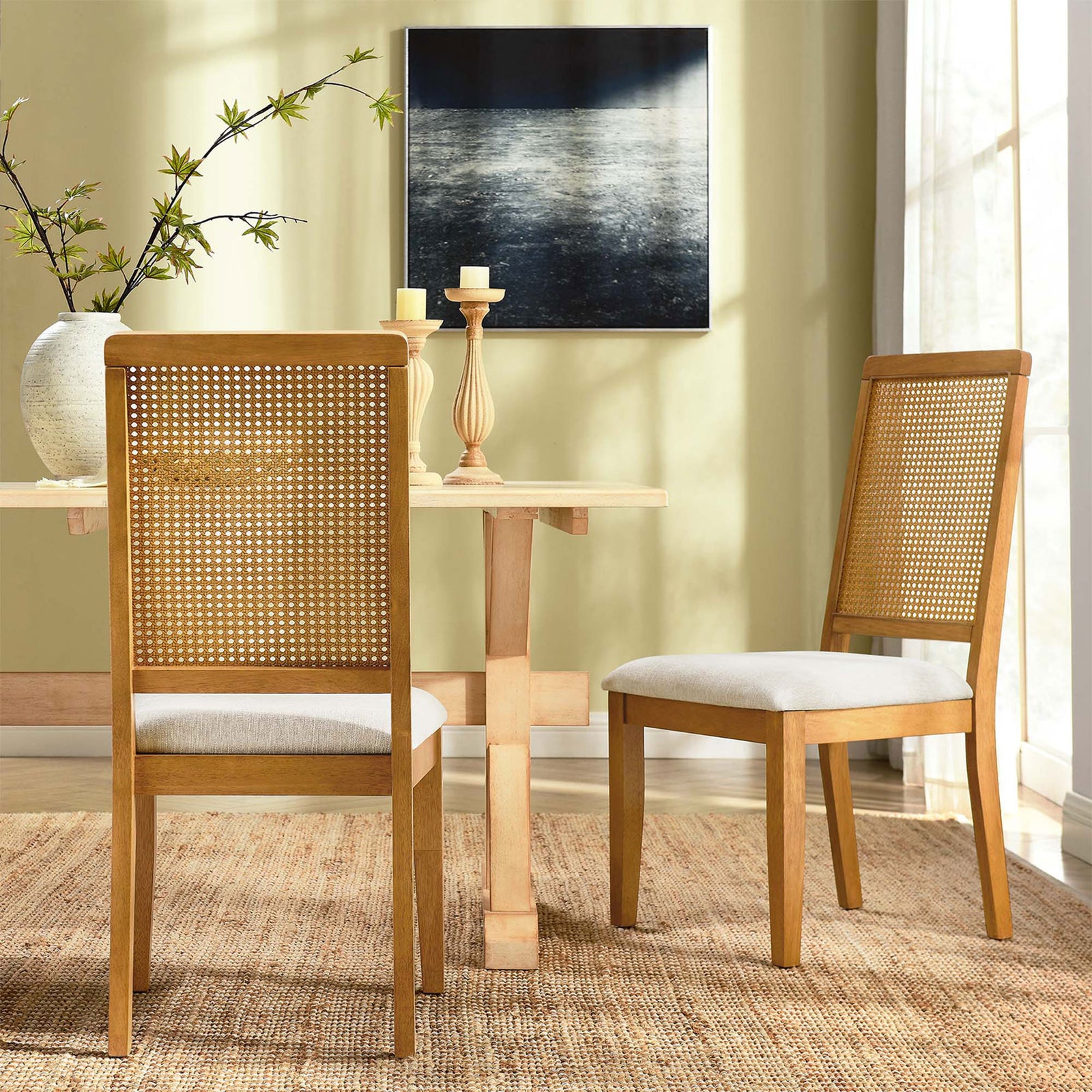 Pair of Arlo dining chairs around a light wood table adding airy texture to a bright dining room || EEI-6803-NAT-NAT-HLB || back_angle_multi_room