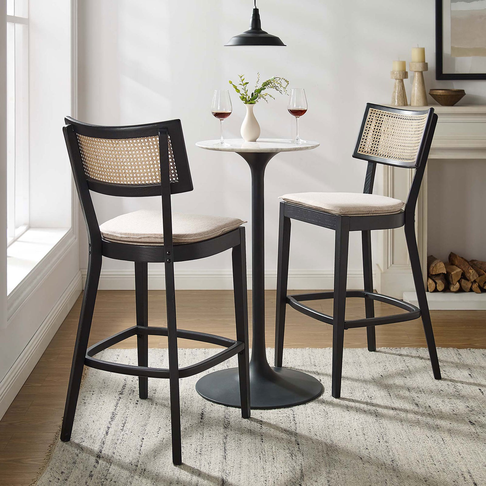 Two bar stools anchor a cozy nook with warm cane and elegant contrast || EEI-6820-BLK-BEI || front_angle_multi_room