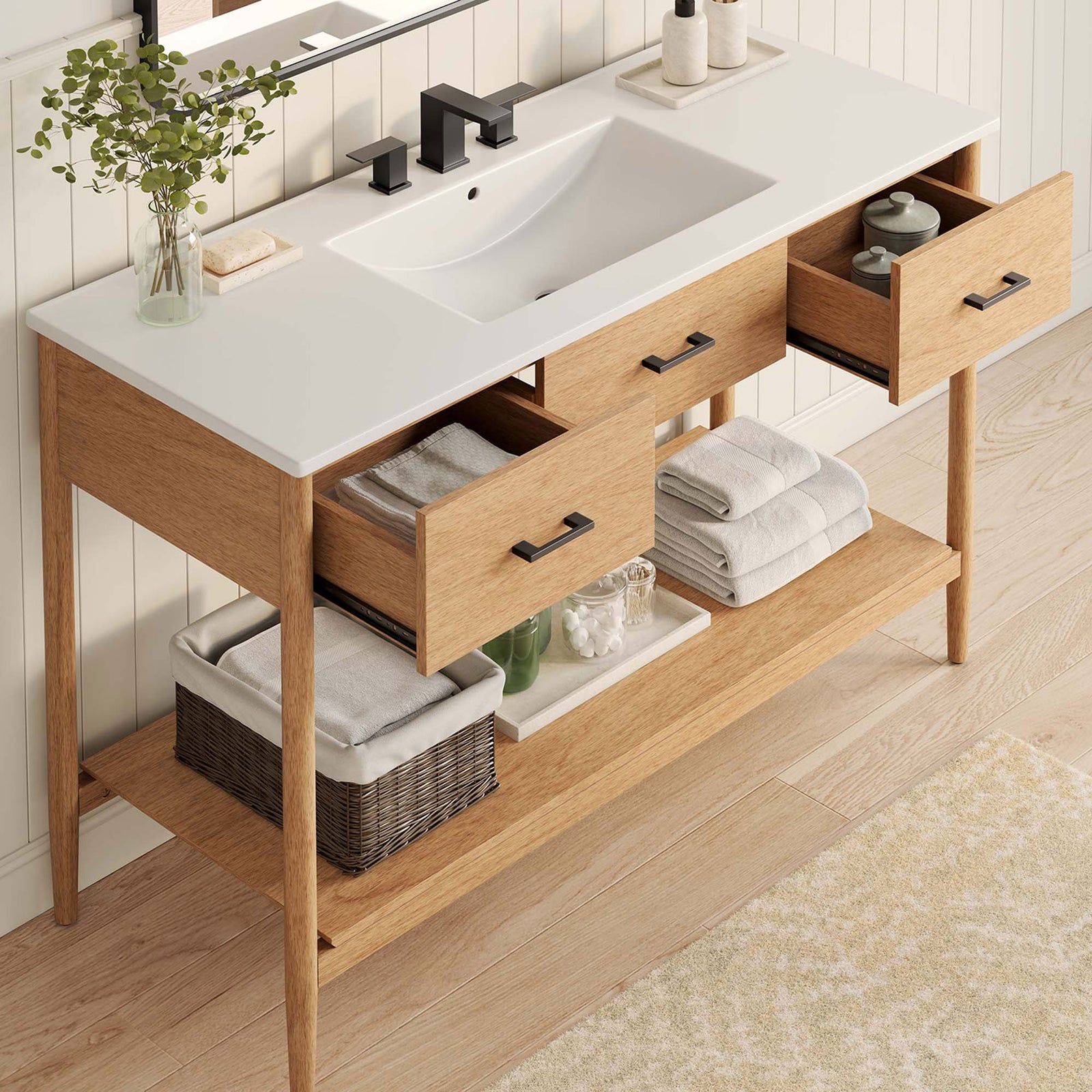 Ample storage with side drawers and an open shelf, topped by a bright white ceramic basin. || EEI-6824-NAT-WHI || front_angle_open_room