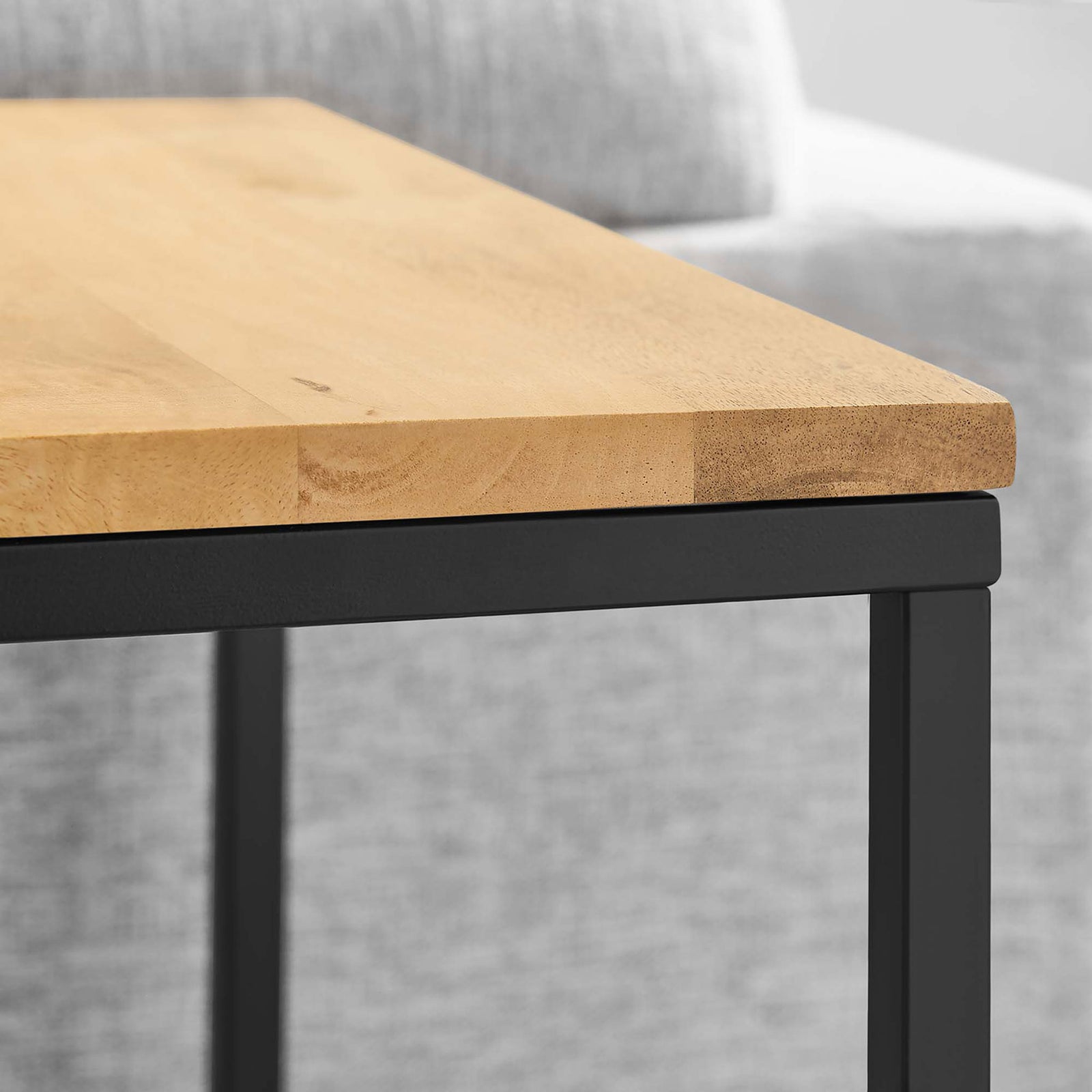 Oak side table top sits beside a gray sofa in a bright modern living room || EEI-6833-OAK || detail_room
