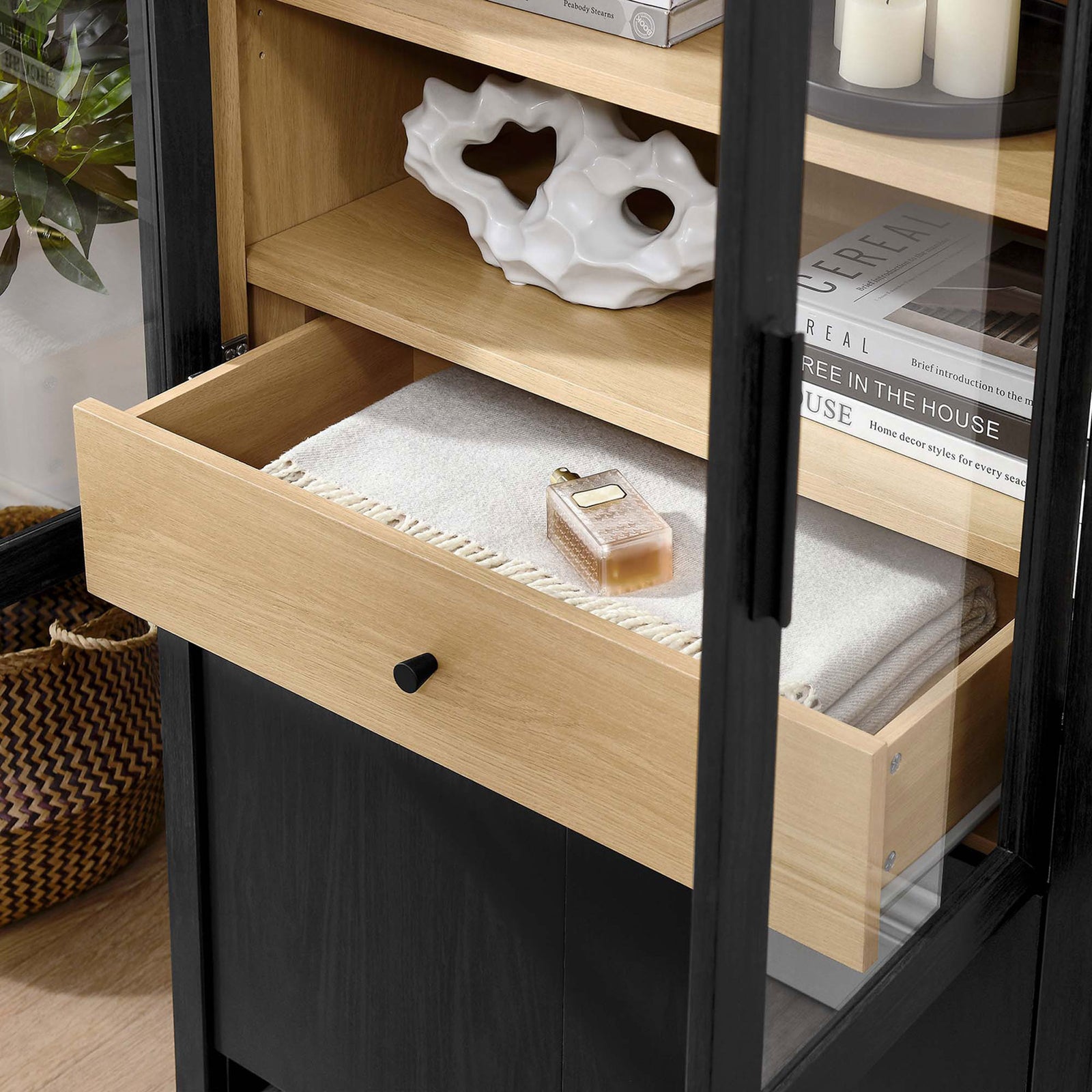Lifestyle close-up of the Evie cabinet drawer neatly storing a throw and decorative accents || EEI-6834-BLK-OAK || storage_open_room