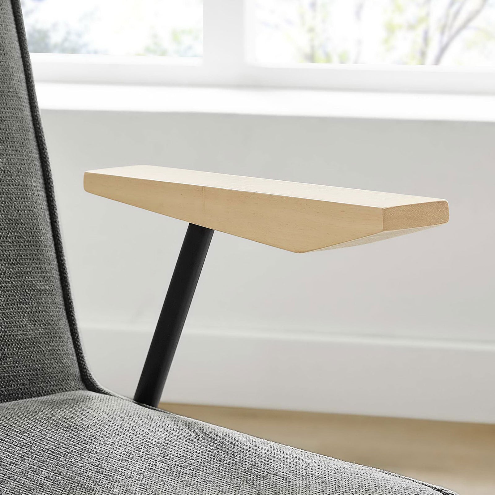 Light wood armrest contrasts with slate upholstery in a bright dining room setting. || EEI-6835-SLA || detail_room