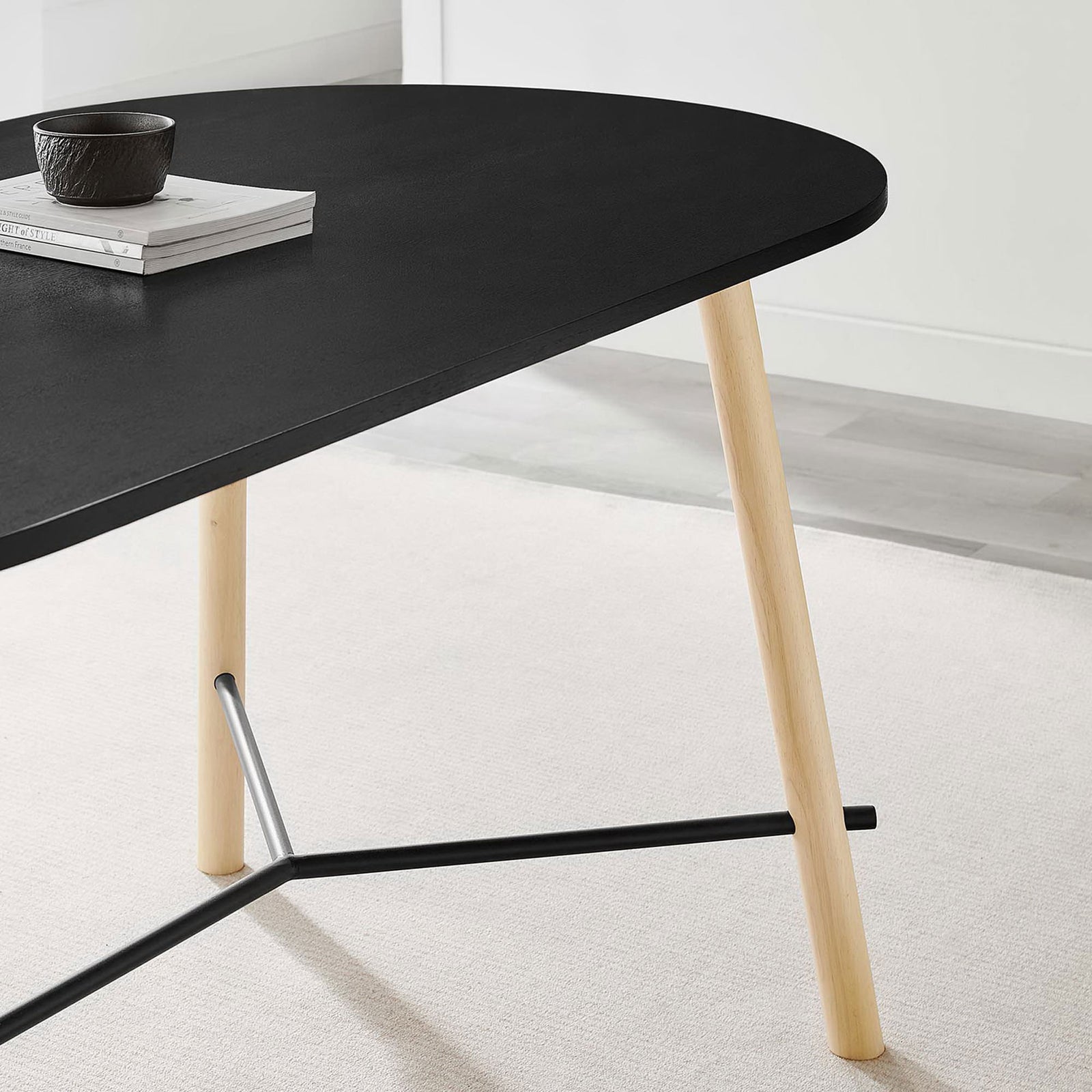 Styled dining tabletop vignette with black finish, light wood leg, and minimalist decor in a bright room || EEI-6836-BLK-OAK || detail_room