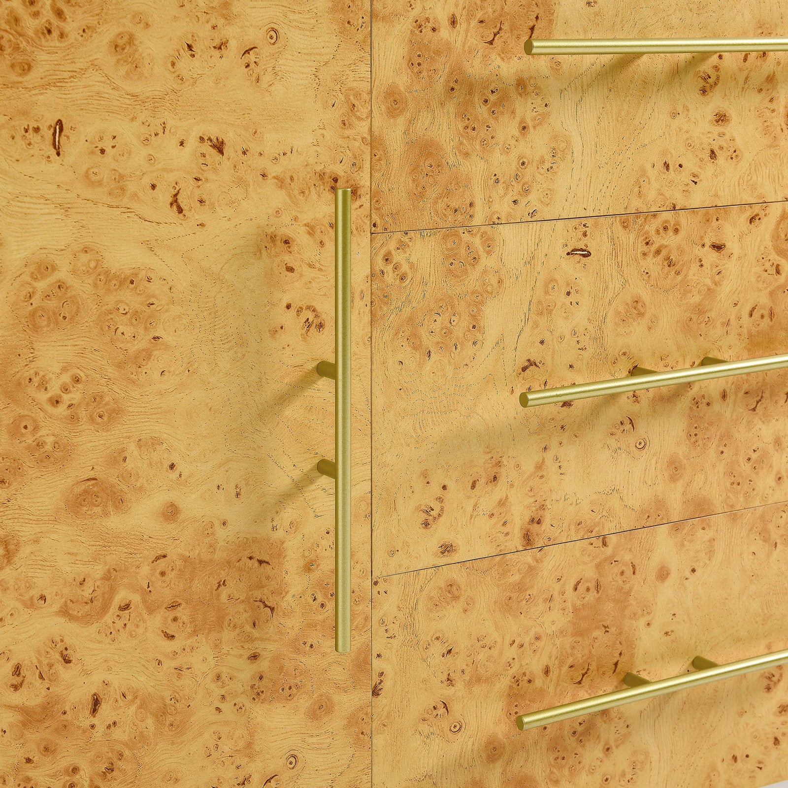Elongated gold-tone pulls stand out against the richly patterned burl wood cabinet front || EEI-6848-WHI-BUR || handle_studio